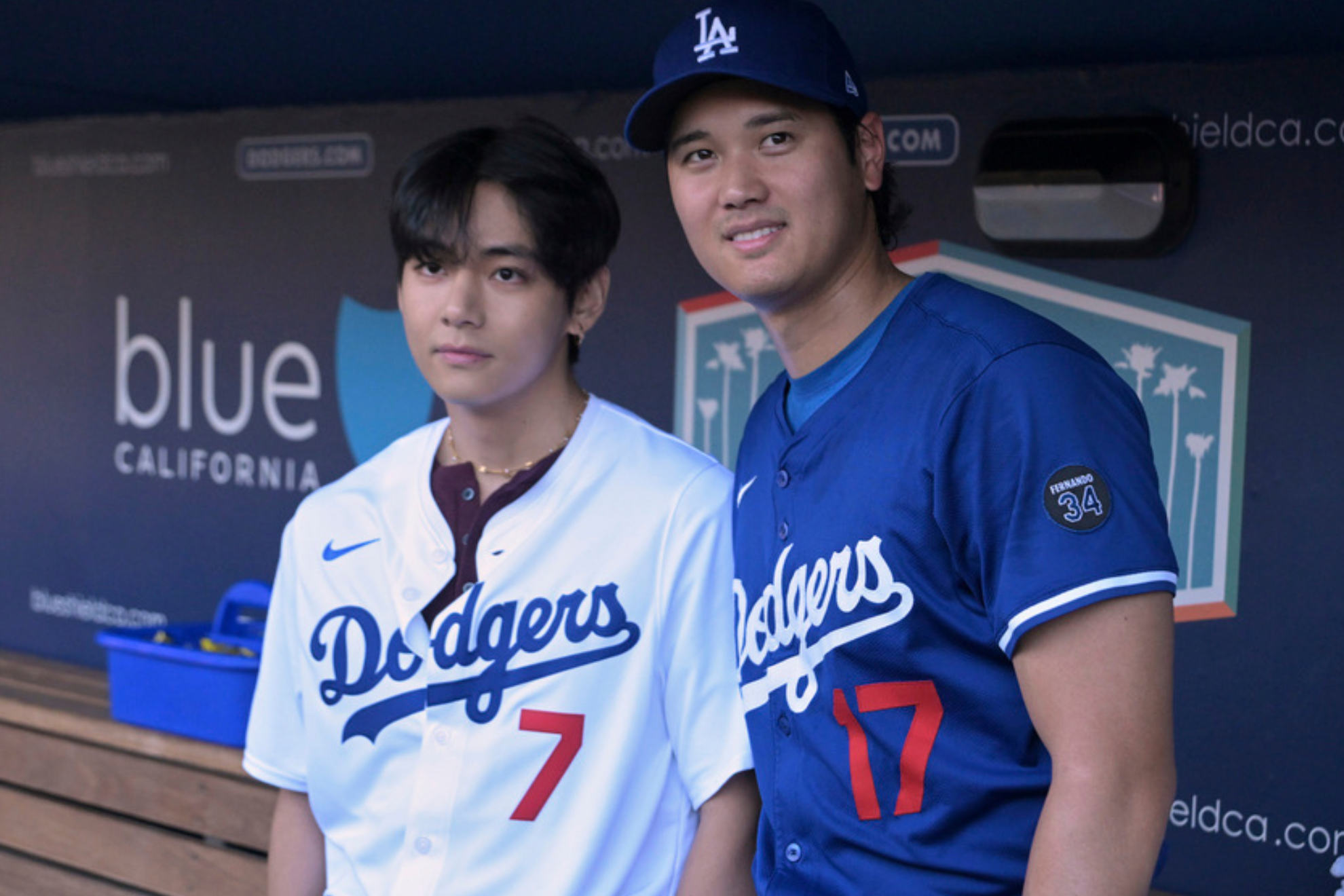 V, a member of the South Korean K-pop band BTS, left, greets Los Angeles Dodgers designated hitter Shohei Ohtani before a baseball game against the Cincinnati Reds Monday, Aug. 25, 2025, in Los Angeles. (AP Photo/Jayne Kamin-Oncea)