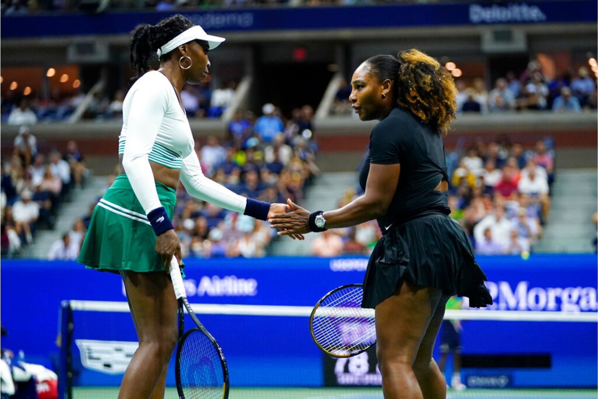 Serena Williams and Venus Williams celebrate during a first-round doubles match at the U.S. Open tennis championships 2022