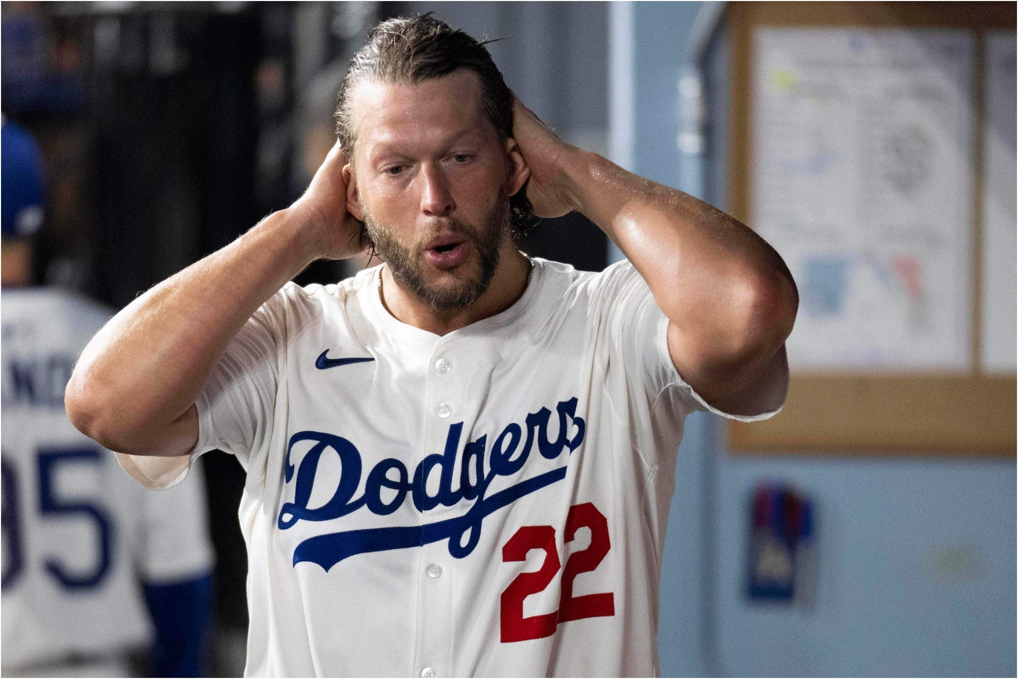 Los Angeles Dodgers starting pitcher Clayton Kershaw (22) walks in the dugout area.