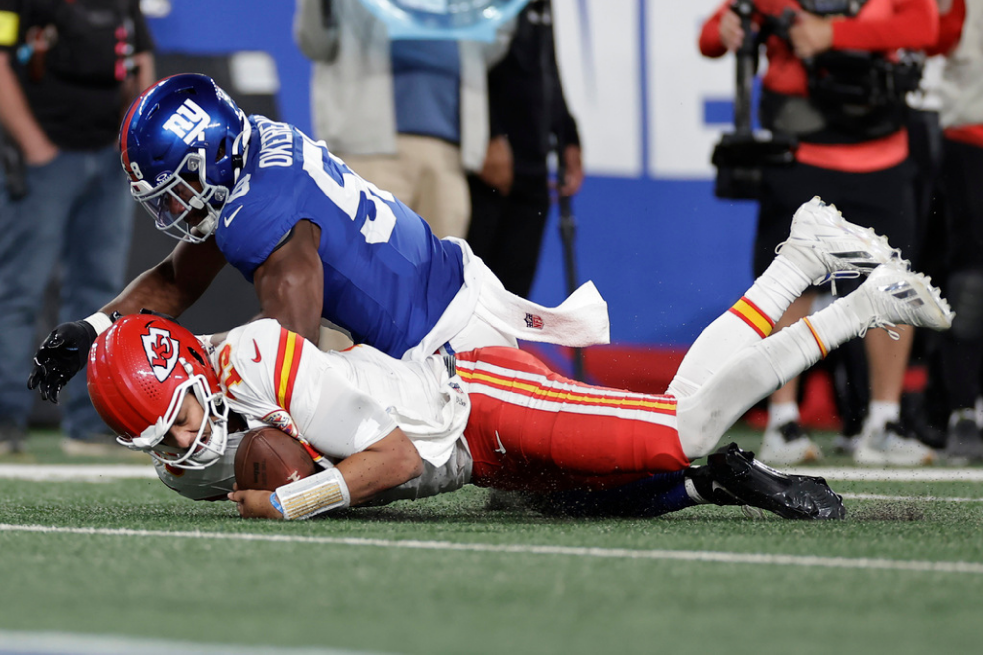 Kansas City Chiefs quarterback Patrick Mahomes, bottom, recovers the ball
