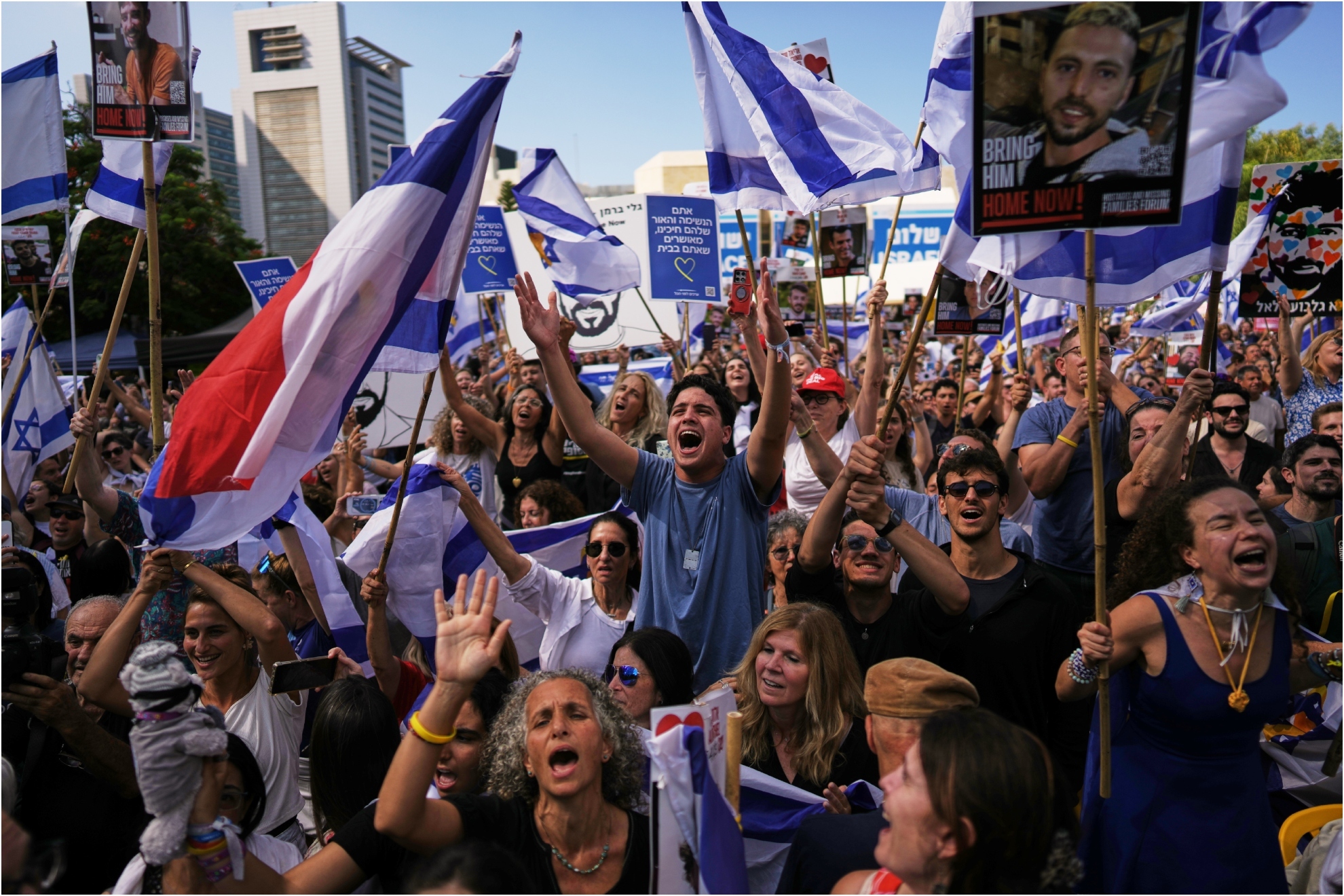People react as they gather to watch a live broadcast of Israeli hostages released from Gaza at a plaza known as hostages square in Tel Aviv, Israel.