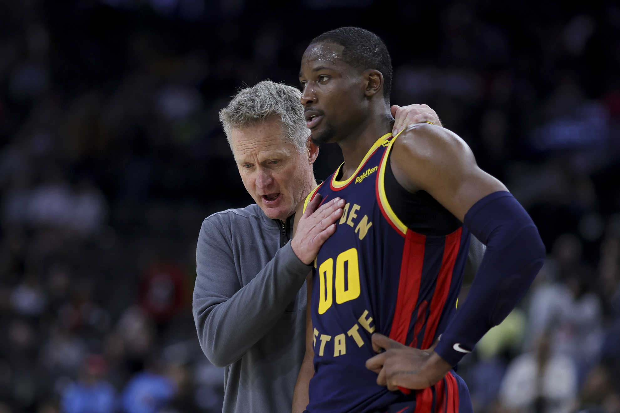 Golden State Warriors head coach Steve Kerr speaks with forward Jonathan Kuminga
