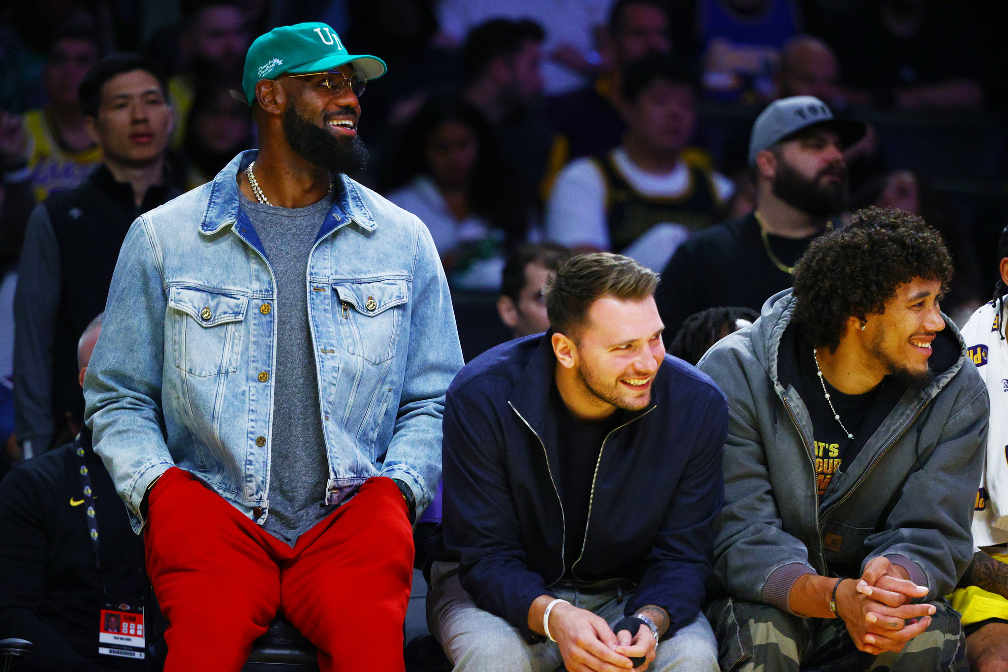 Los Angeles Lakers forward LeBron James (23) and Los Angeles Lakers guard Luka Doncic (77) watch from the bench during the NBA basketball game against the Portland Trail Blazers
