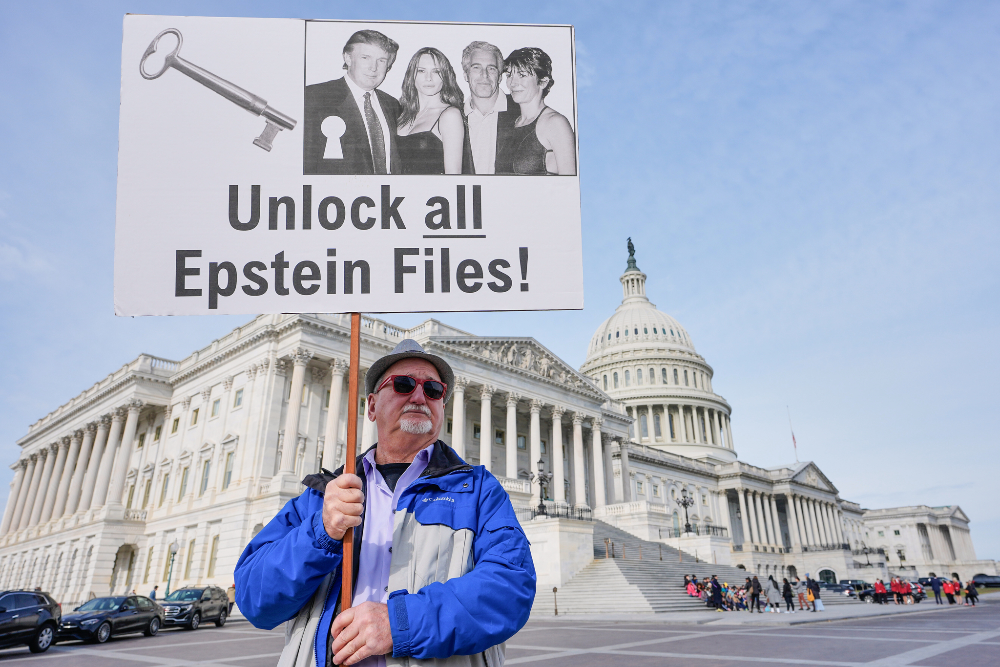 Gary Rush, College Park, MD, holds a sign before a news conference on Epstein files
