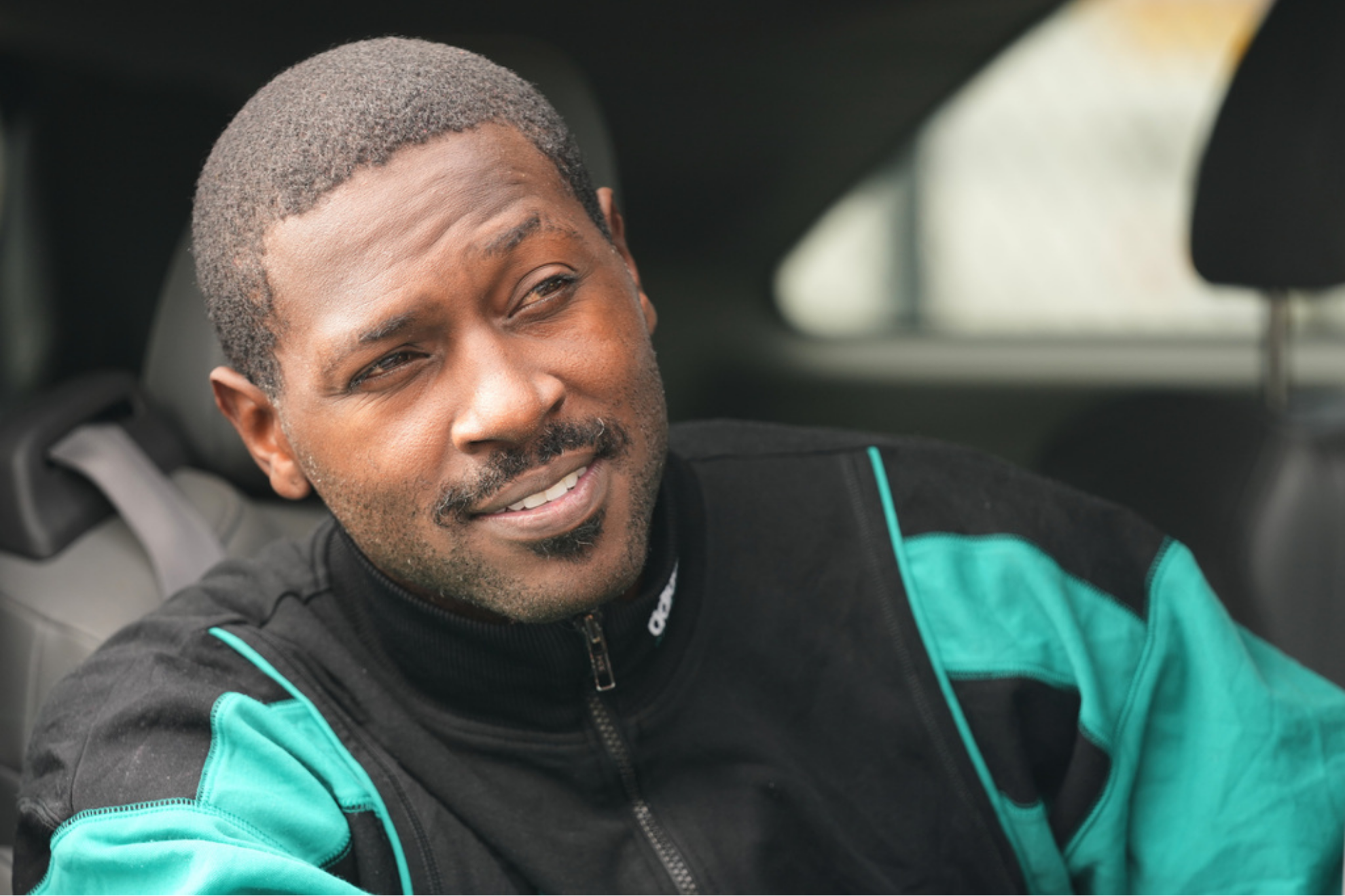 Former NFL star wide receiver Antonio Brown smiles from a vehicle after being released from the Turner Guilford Knight Correctional Center,