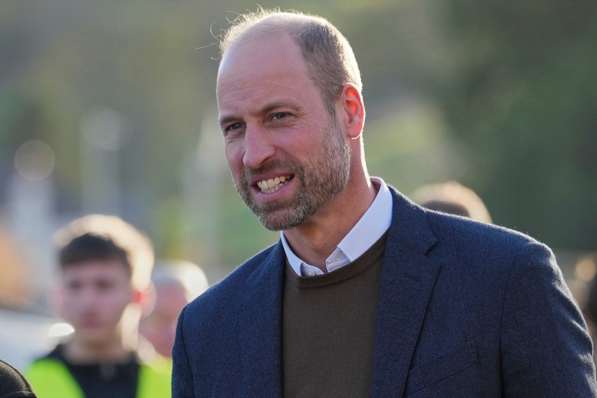 Prince William resists ignoring a womans grip as she desperately tries to speak to him