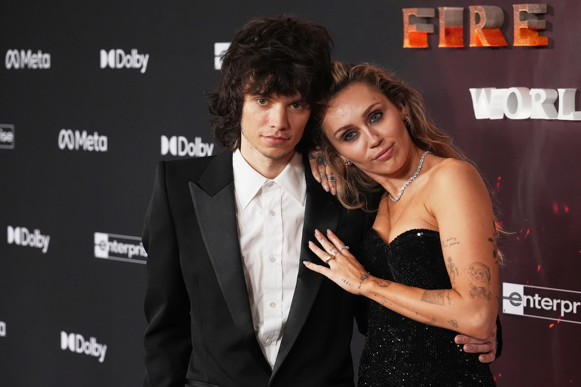 Miley Cyrus poses for photographers with Maxx Morando