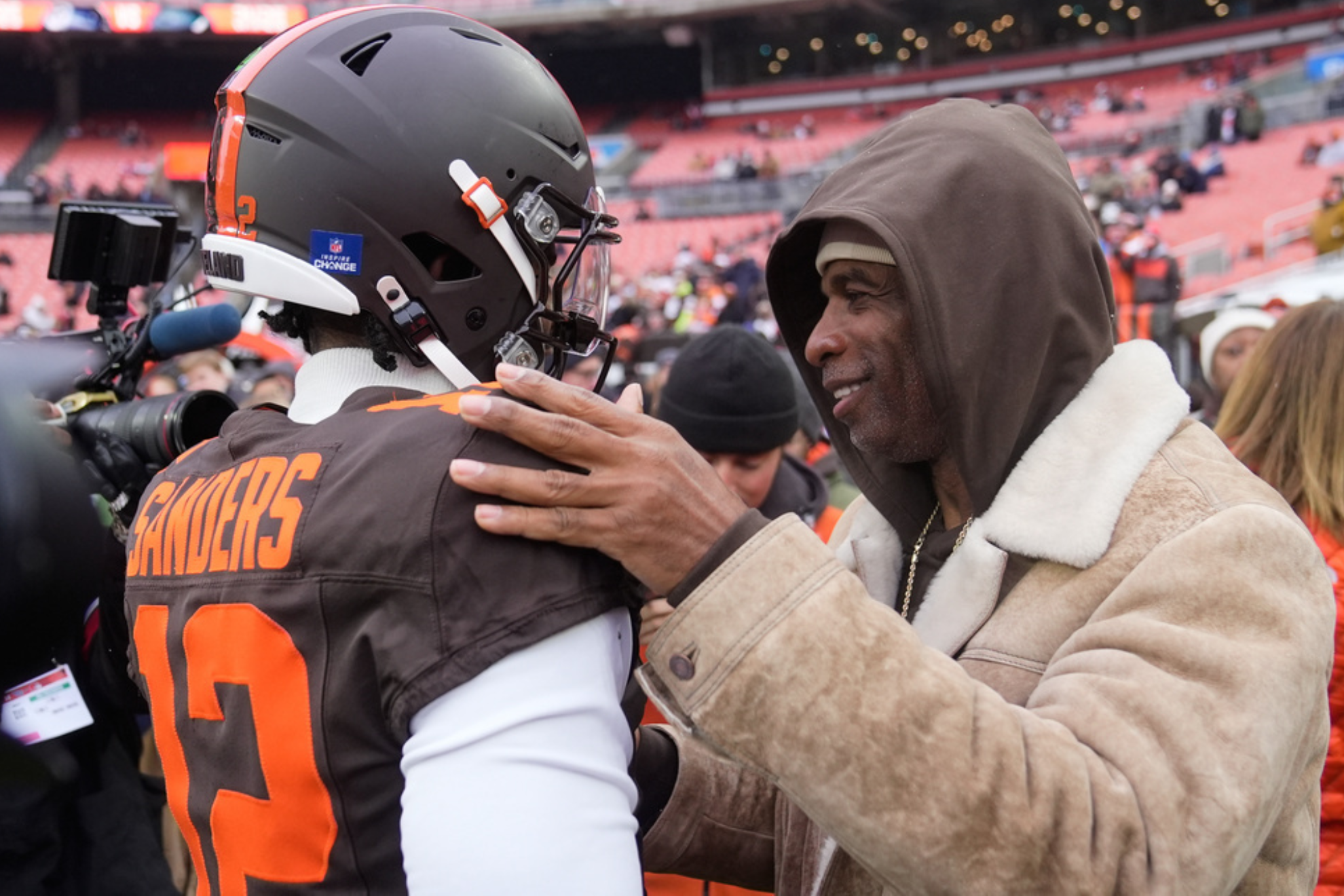 Deion Sanders meets Shedeur Sanders on the field after the Cleveland Browns 31-29 loss to the Tennessee Titans in Week 14 of the 2025 NFL regular season.