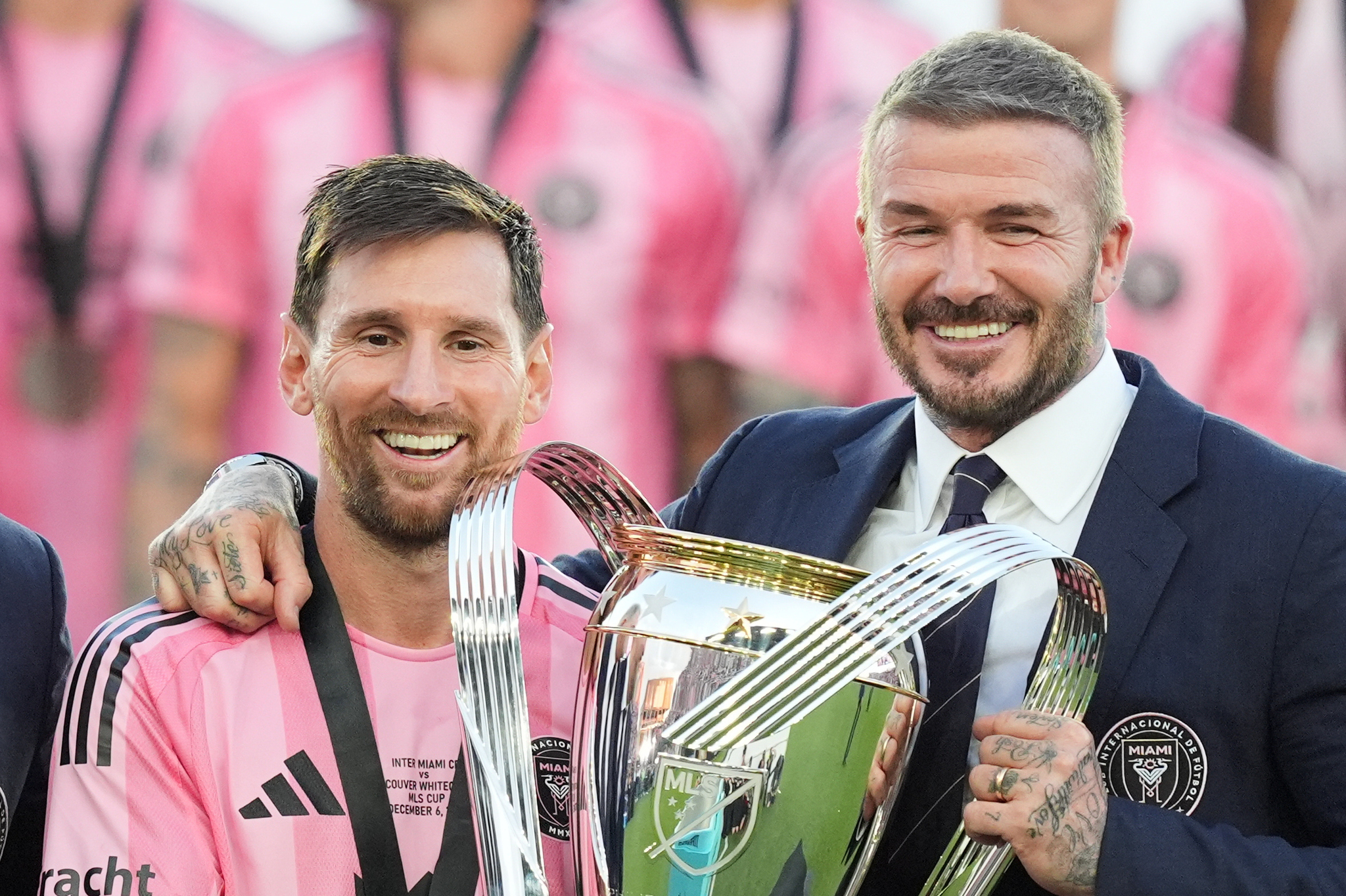 David Beckham poses with the MLS Cup trophy with Inter Miami forward Lionel Messi