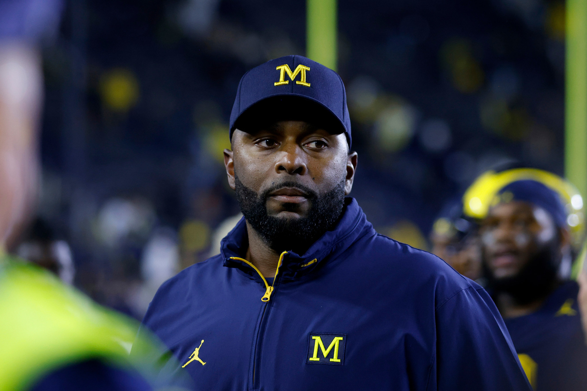 Michigan coach Sherrone Moore walks off the field following an NCAA football game