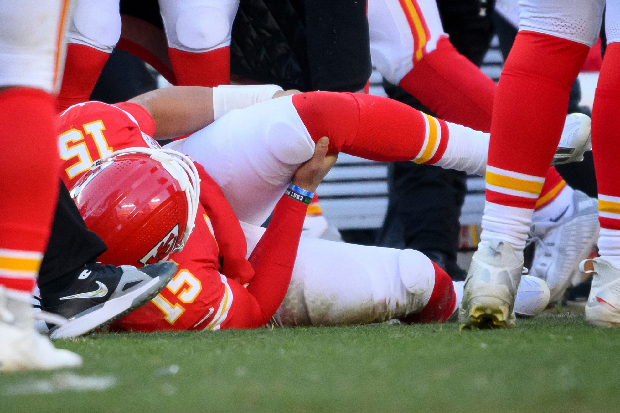 Kansas City Chiefs quarterback Patrick Mahomes holds his knee after tearing his ACL and LCL in a game against the Los Angeles Chargers.