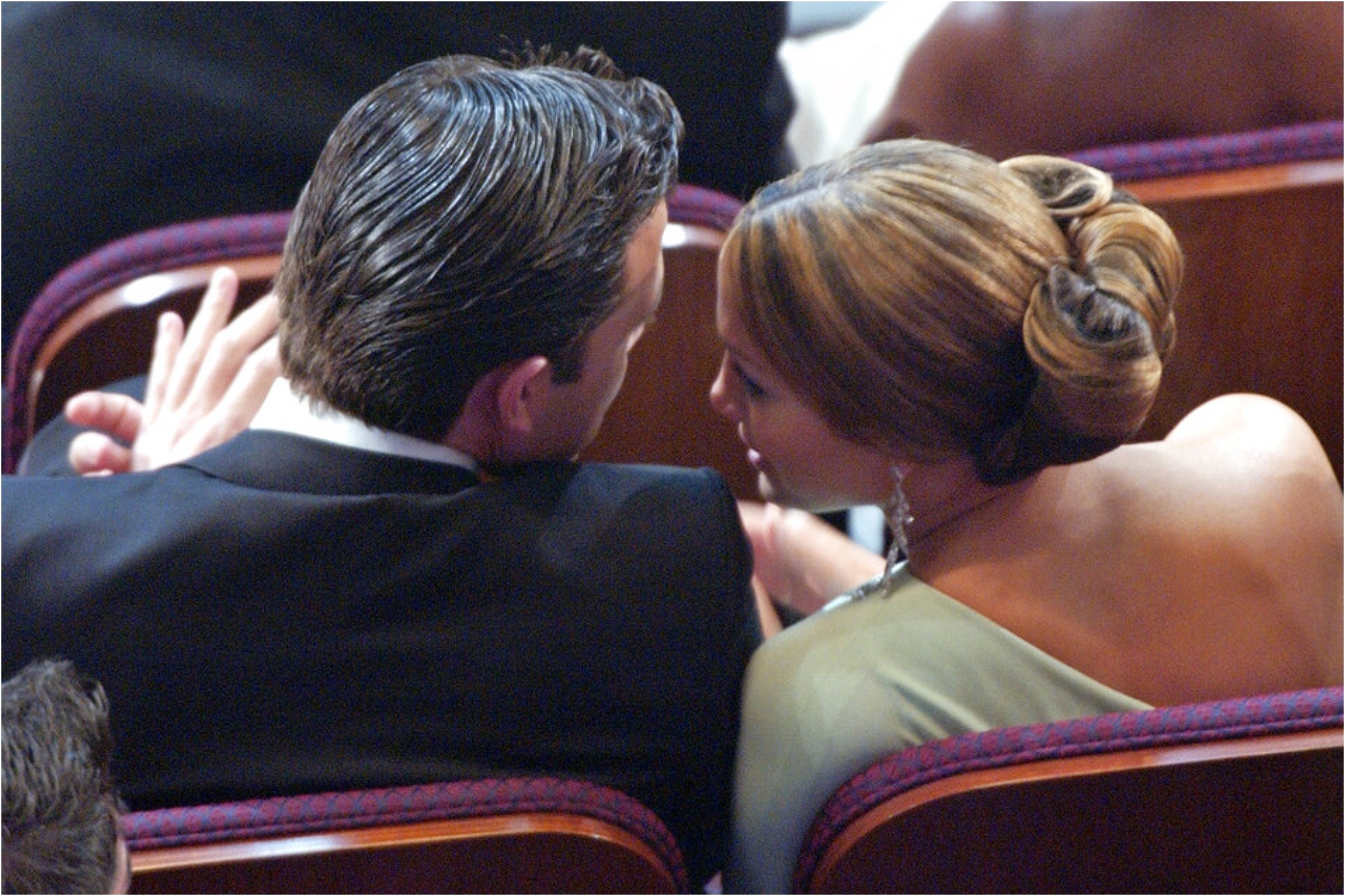Jennifer Lopez leans over to speak to Ben Affleck.