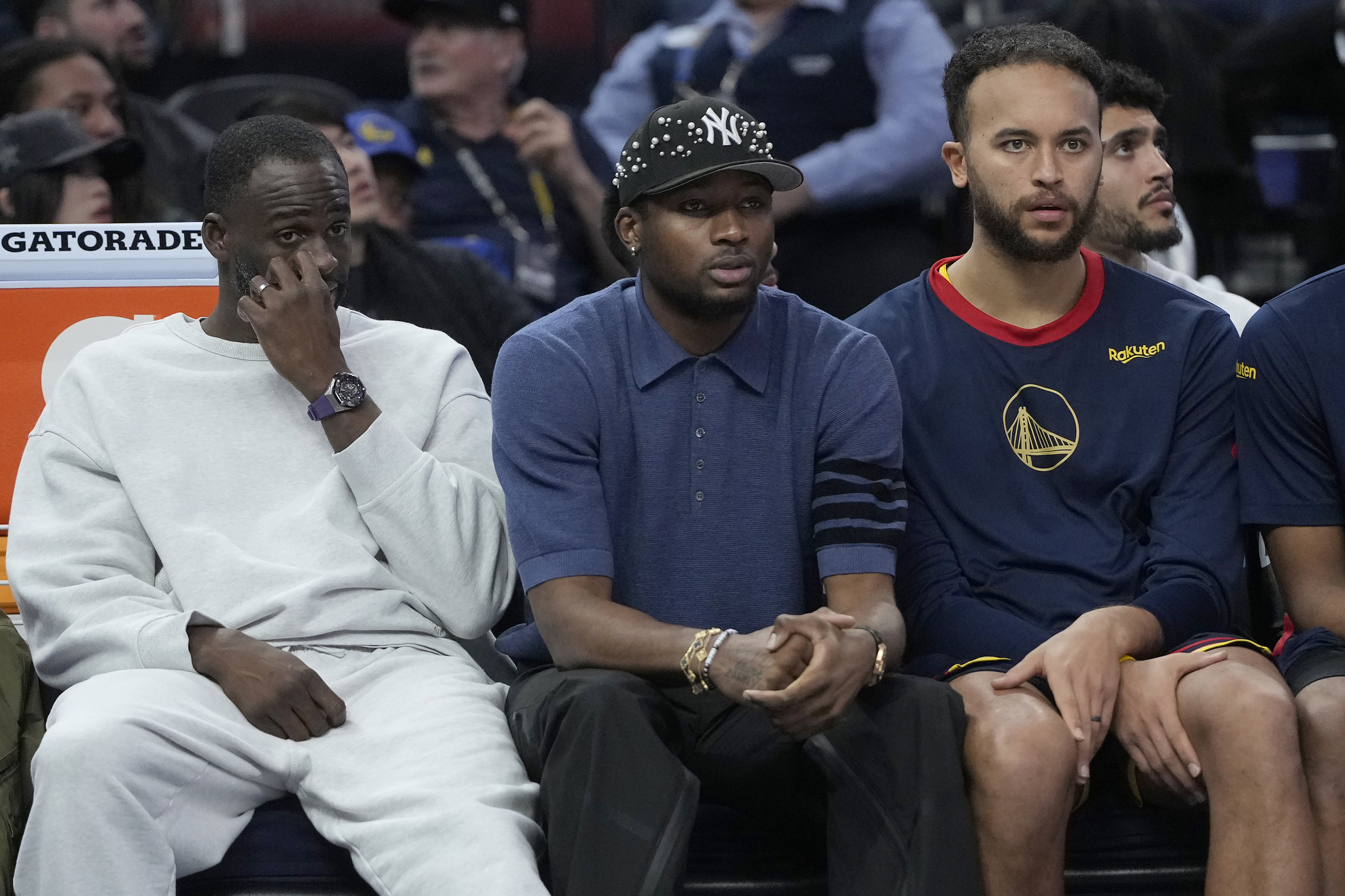 Golden State Warriors forward Draymond Green reacts on the bench with forward Jonathan Kuminga and Kyle Anderson