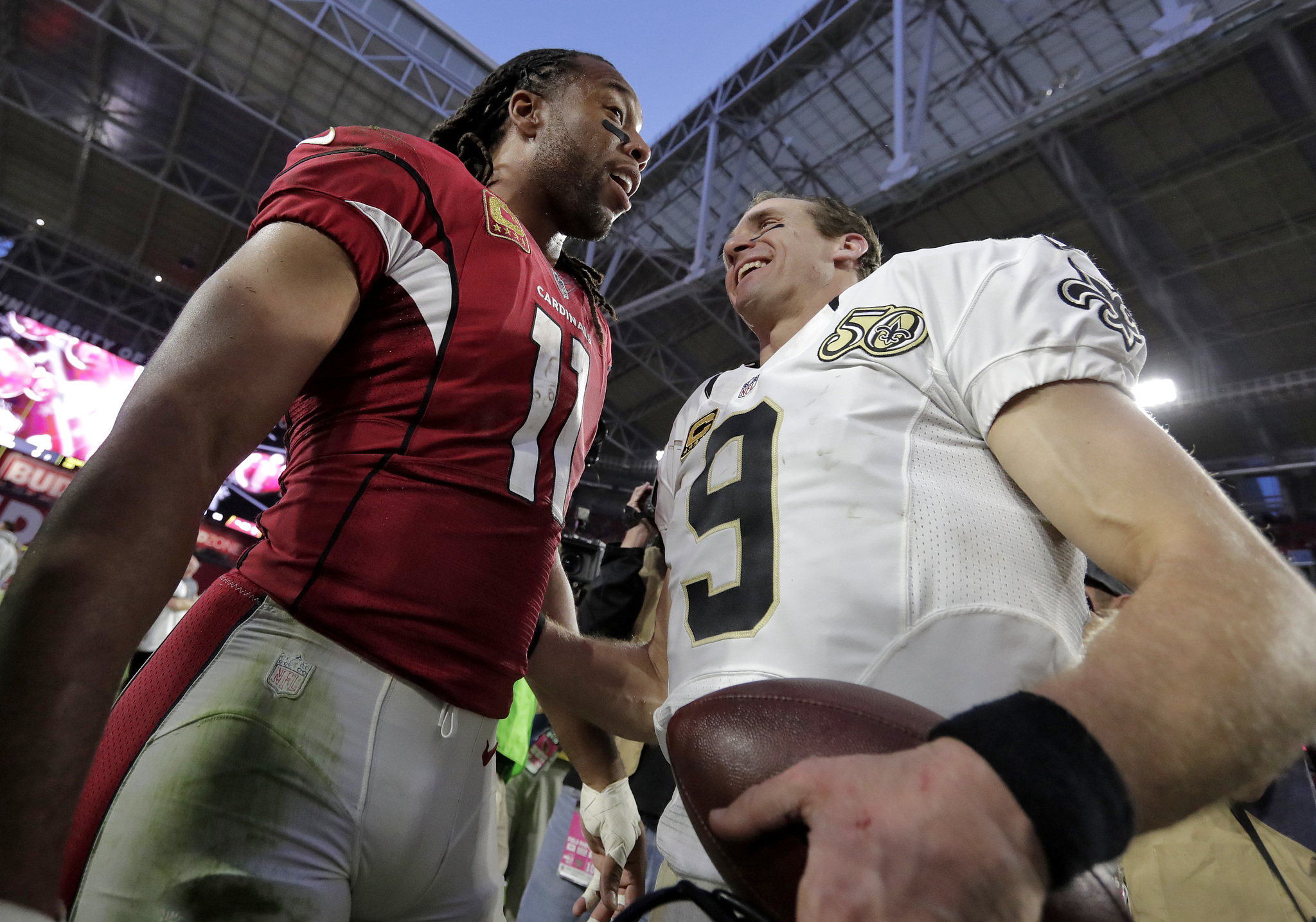 Arizona Cardinals wide receiver Larry Fitzgerald (11) greets New Orleans Saints quarterback Drew Brees (9) after an NFL football game