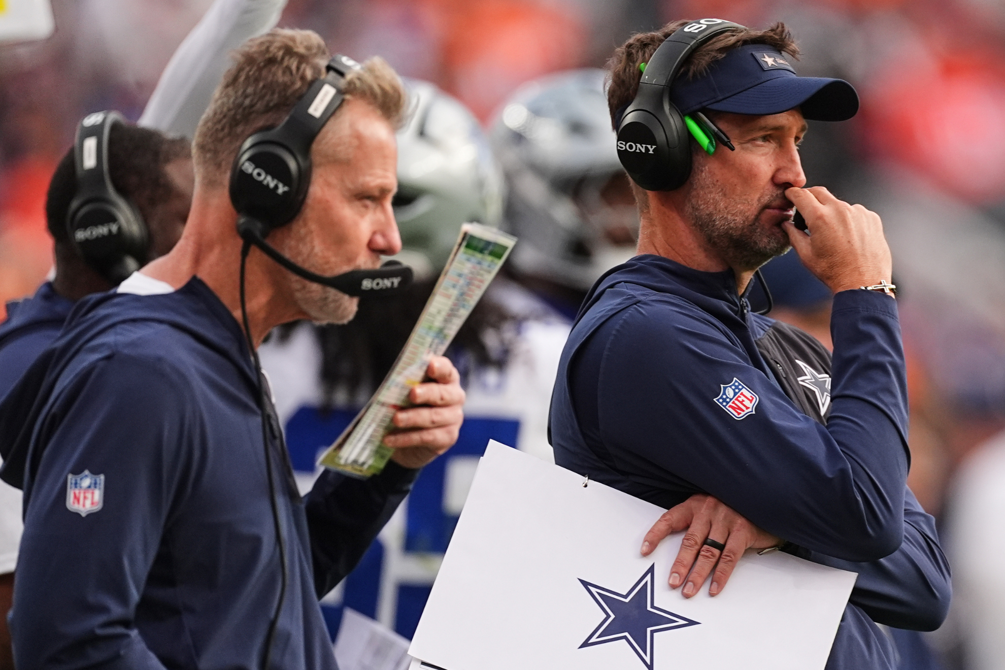 Dallas Cowboys head coach Brian Schottenheimer (right) has a top name in mind to replace defensive coordinator Matt Eberflus (left).