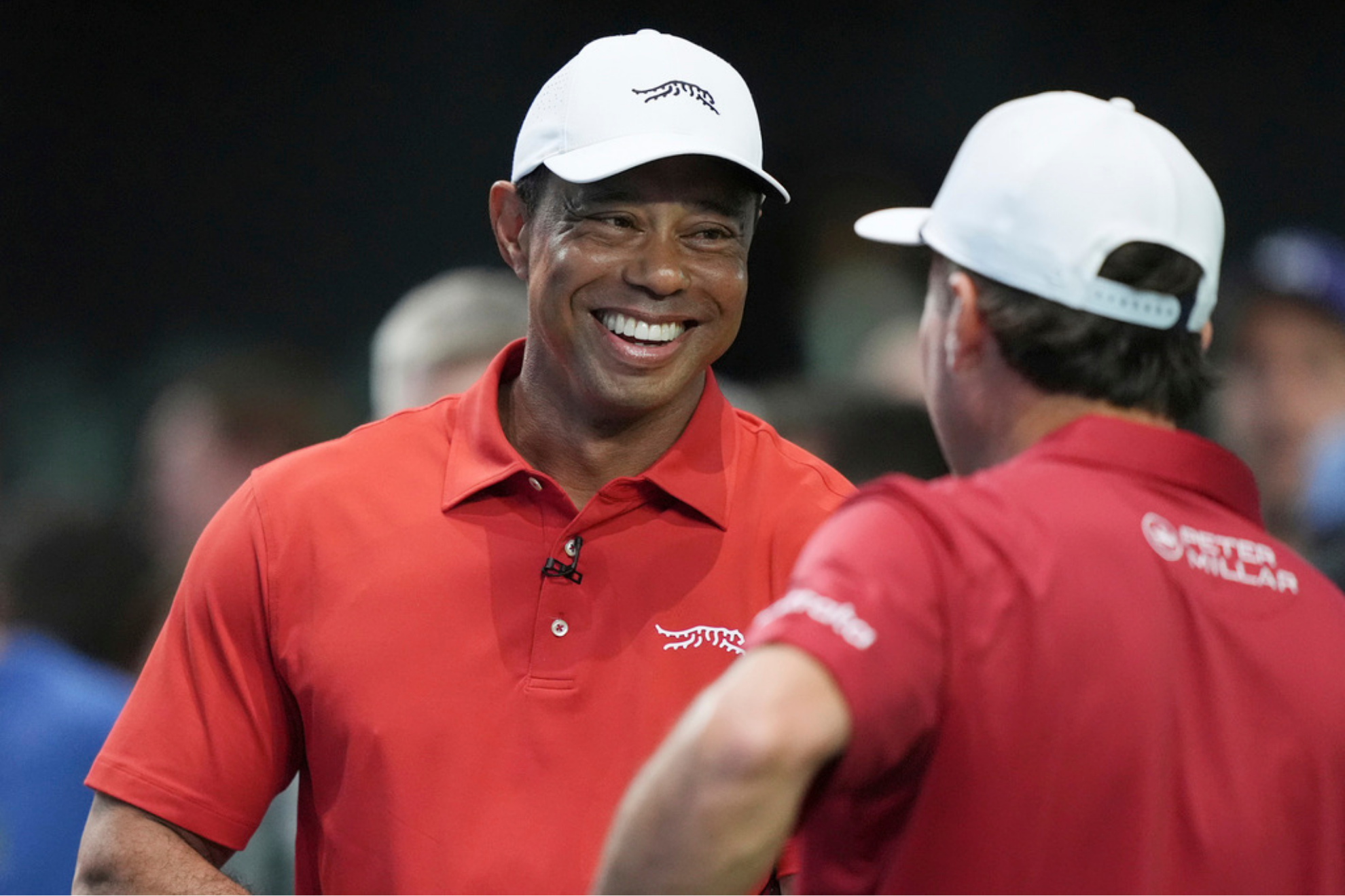 Tiger Woods talks to his Jupiter Links Golf Club teammate Kevin Kisner