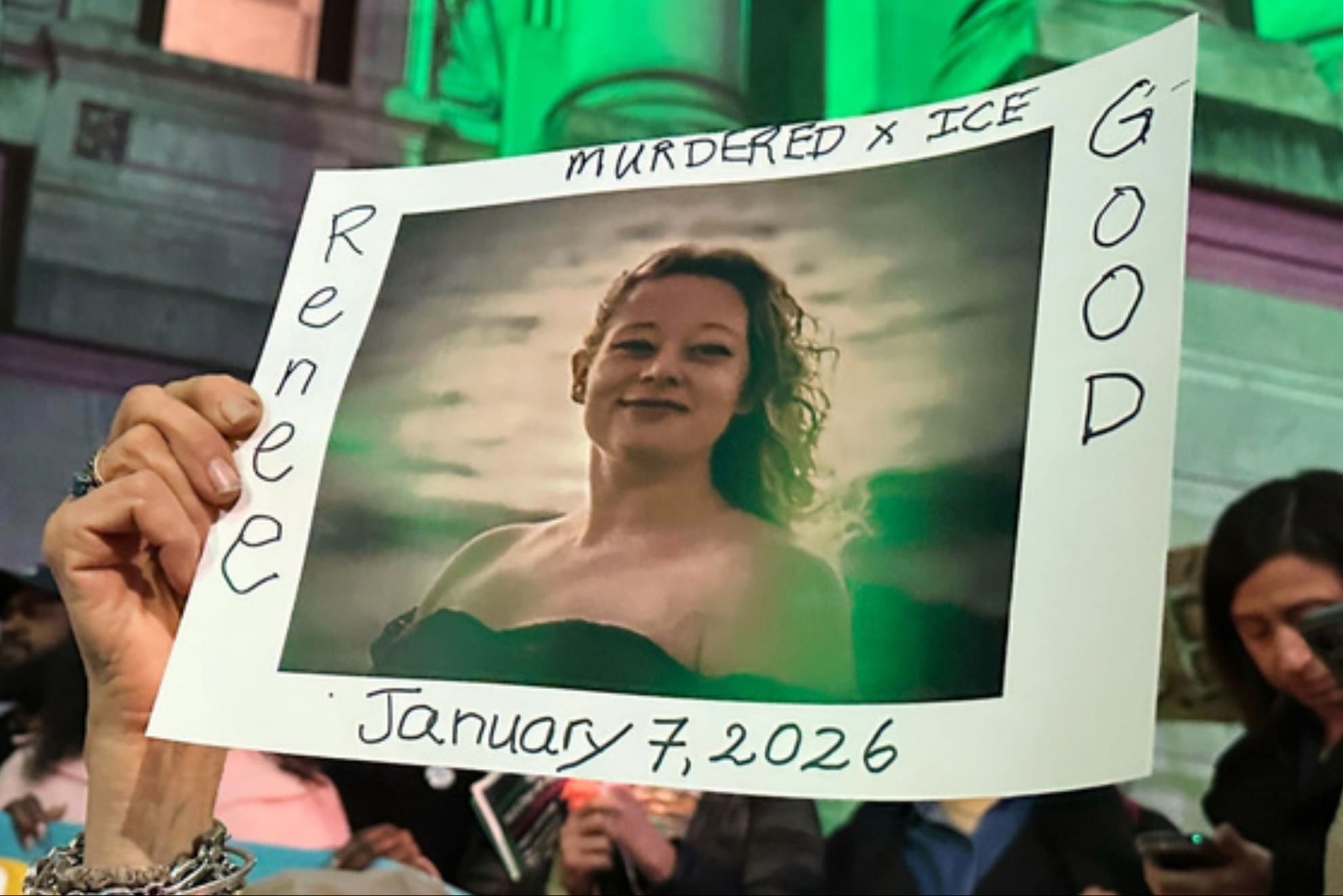 People gather at an anti-immigration enforcement rally and vigil for Renee Good, who was shot and killed by an ICE officer.