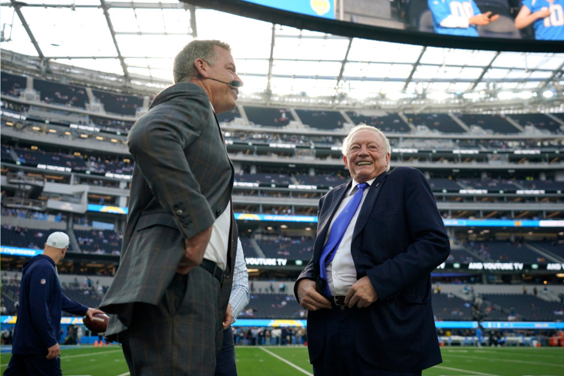 Former Dallas Cowboys quarterback Troy Aikman, left, and Cowboys owner Jerry Jones speak before an NFL football game