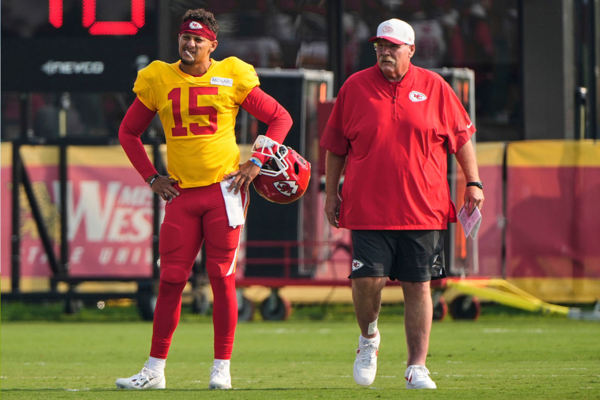 Kansas City Chiefs quarterback Patrick Mahomes (15) and head coach Andy Reid watch practice at NFL football training cam