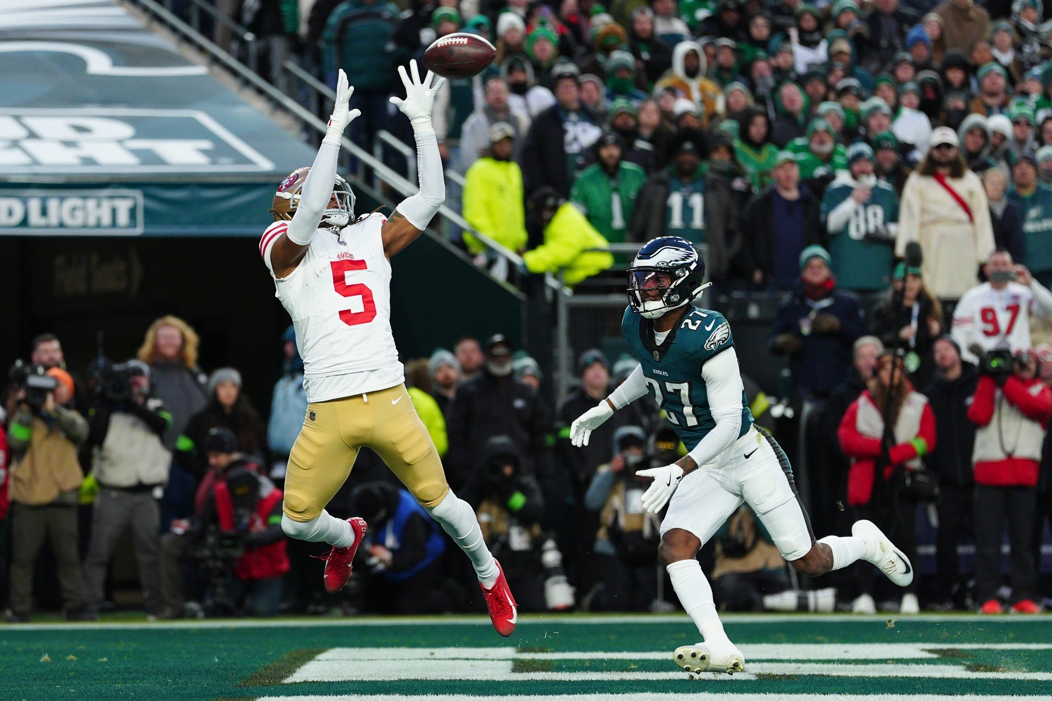 San Francisco 49ers wide receiver Demarcus Robinson scores a touchdown in front of Philadelphia Eagles cornerback Quinyon Mitchell during the first half of an lt;HIT gt;NFL lt;/HIT gt; wild-card playoff football game Sunday, Jan. 11, 2026, in Philadelphia.