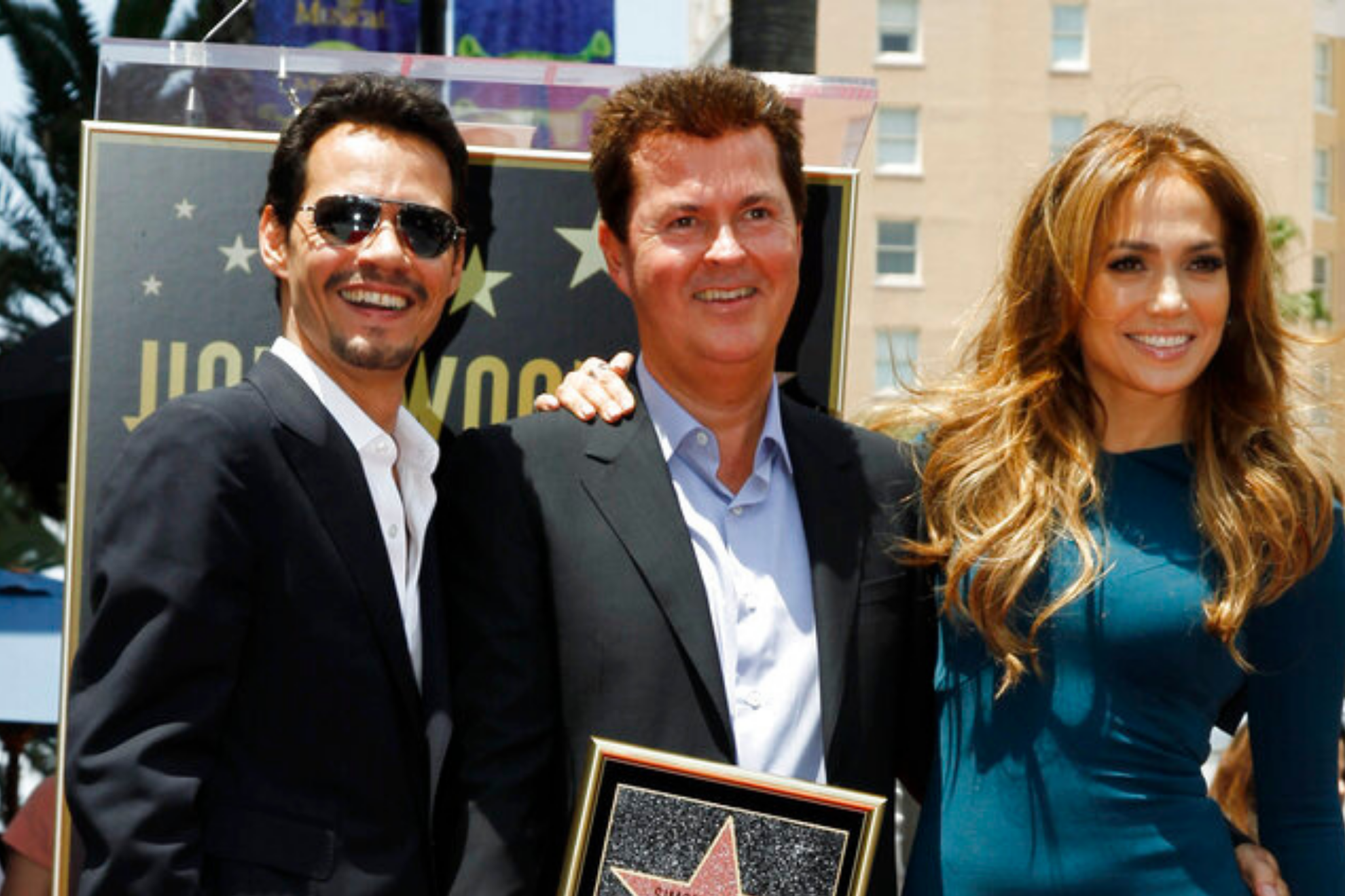 Entertainment producer Simon Fuller, center, poses with Marc Anthony, left, and Jennifer Lopez after receiving a star on the Hollywood Walk of Fame in Los Angeles