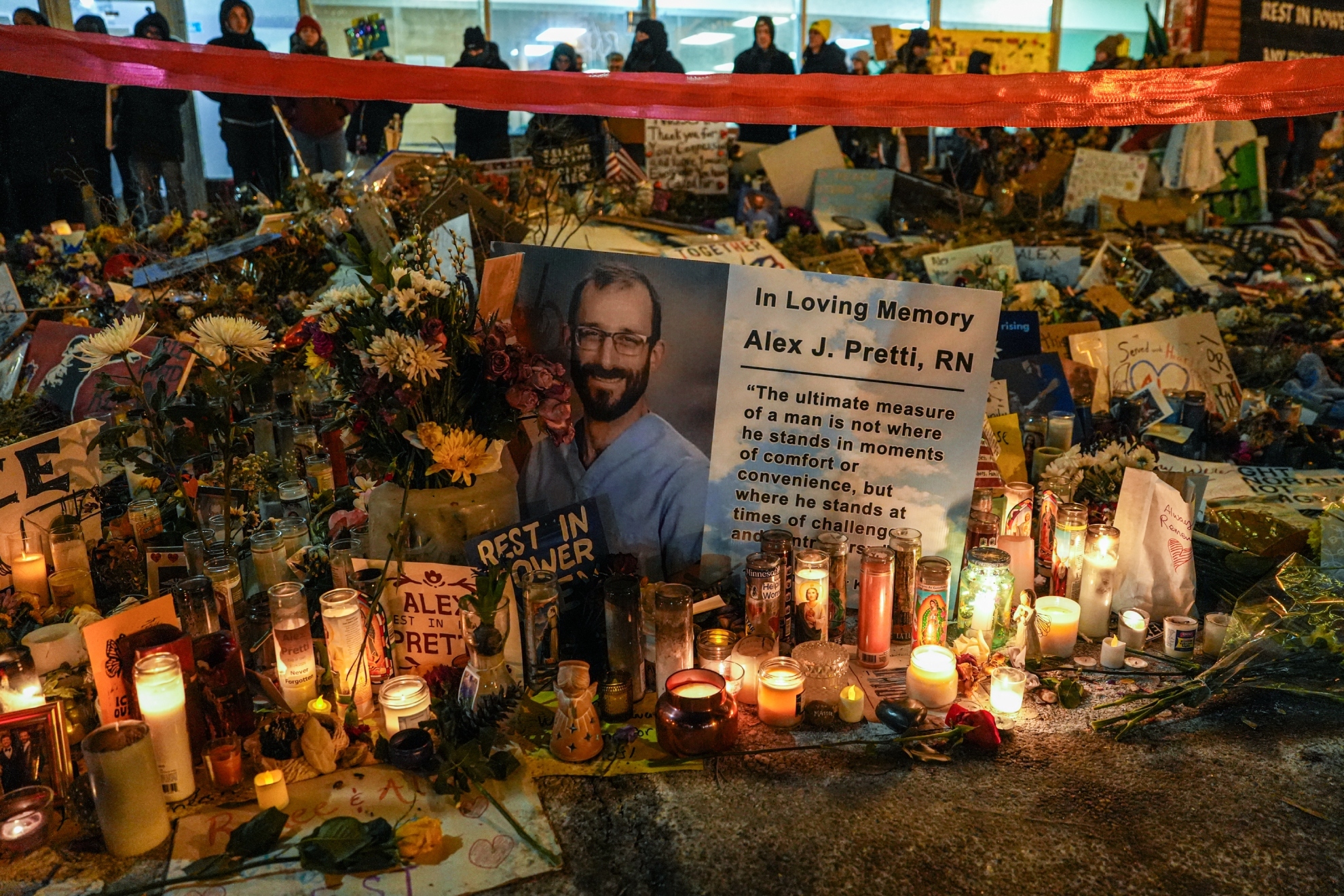People visit a makeshift memorial for 37-year-old Alex Pretti, who was fatally shot by a U.S. Border Patrol officer.