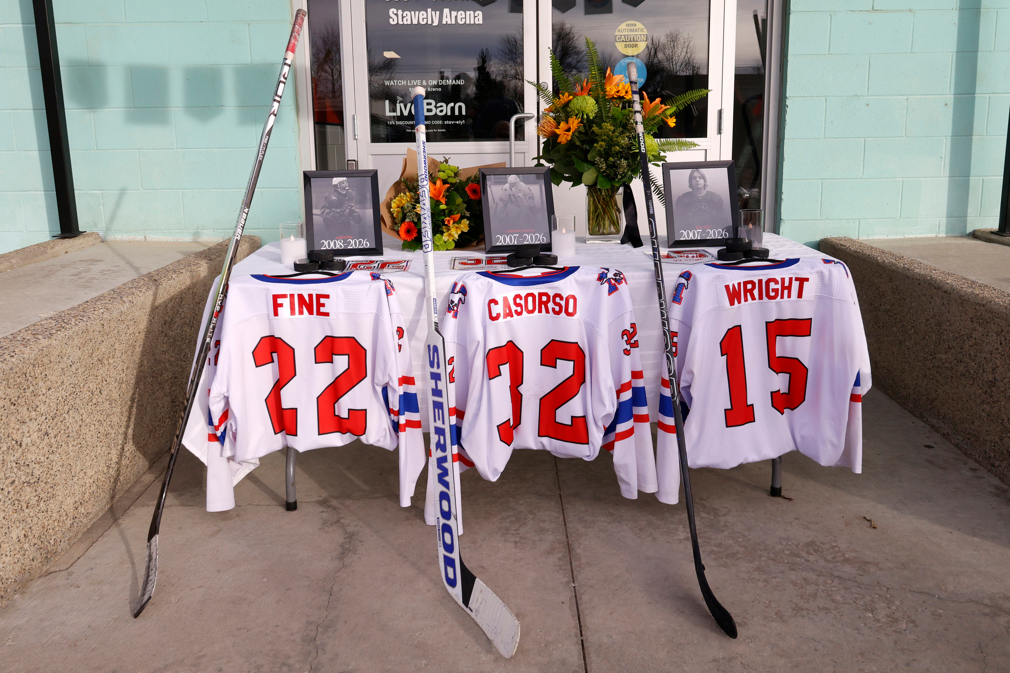Jerseys at a memorial pay tribute to three hockey players killed in a car crash