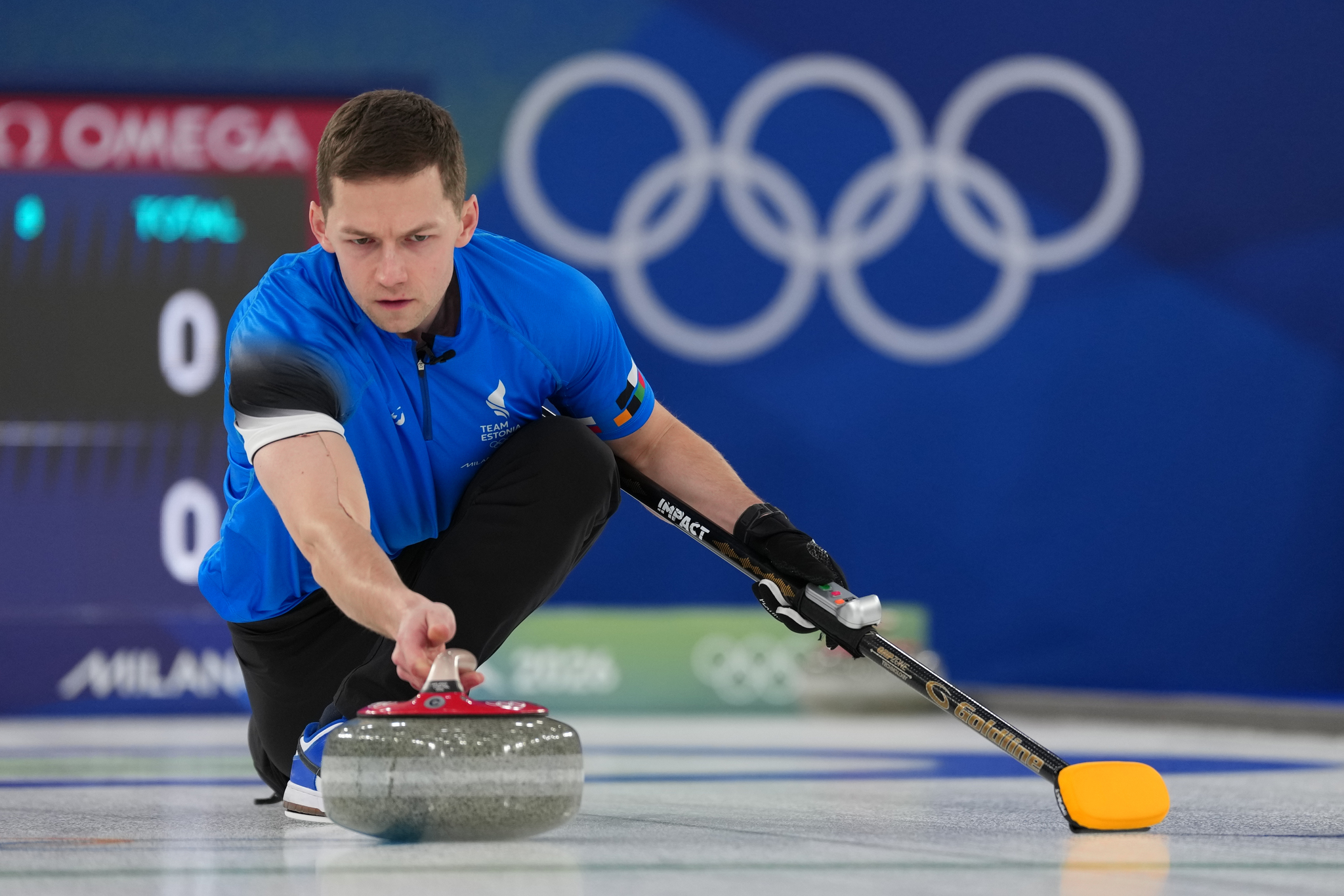 Estonias Harri Lill in action during the mixed doubles round robin phase of the curling competition against Sweden at the 2026 Winter Olympics