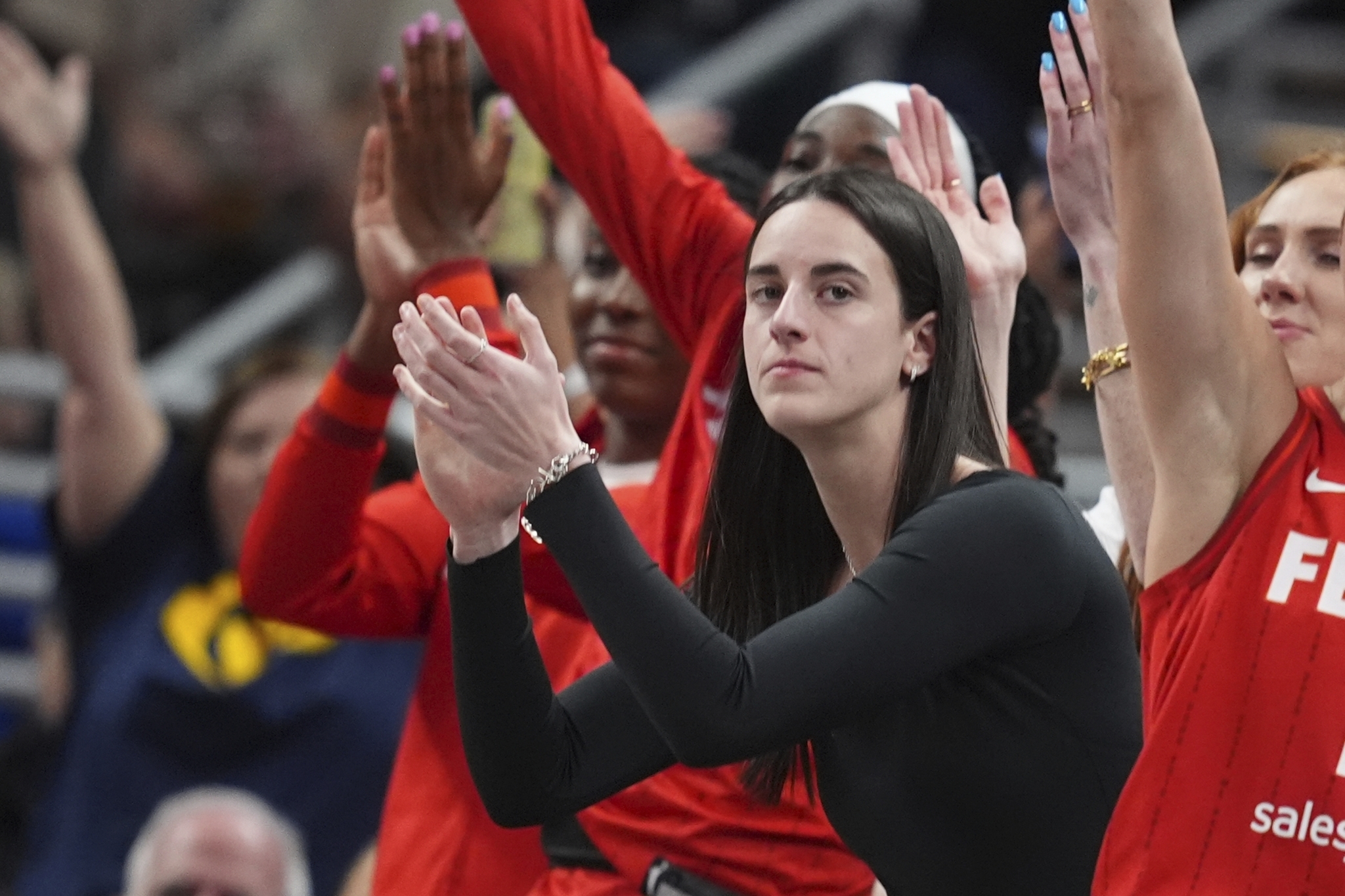 Indiana Fevers Caitlin Clark cheers during the first half of a WNBA basketball game against the Chicago Sky