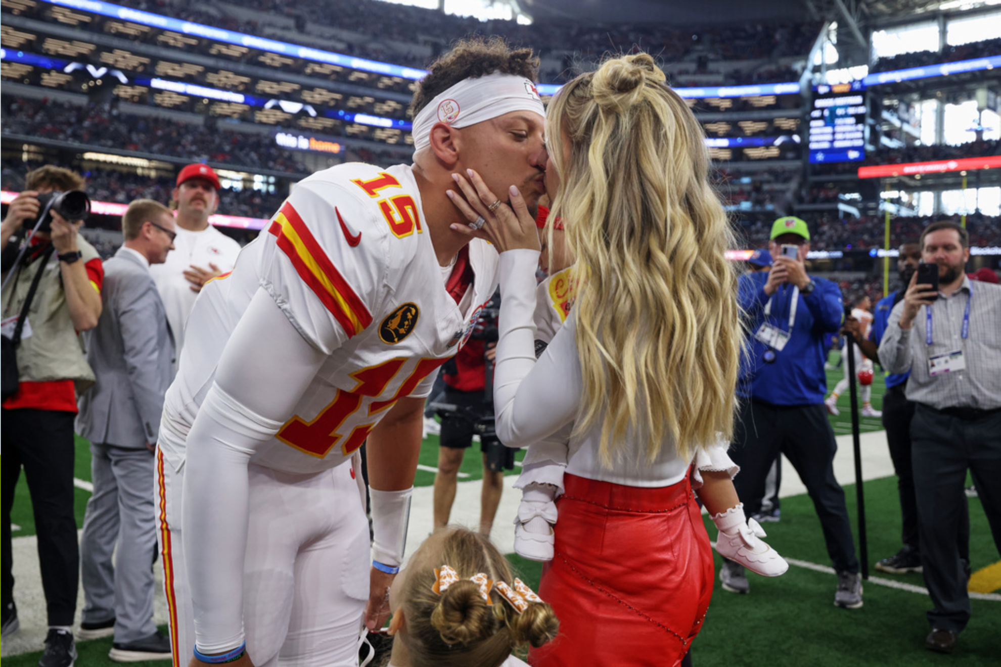 Kansas City Chiefs quarterback Patrick Mahomes (15) kisses his wife, Brittany Mahomes, before an NFL football game
