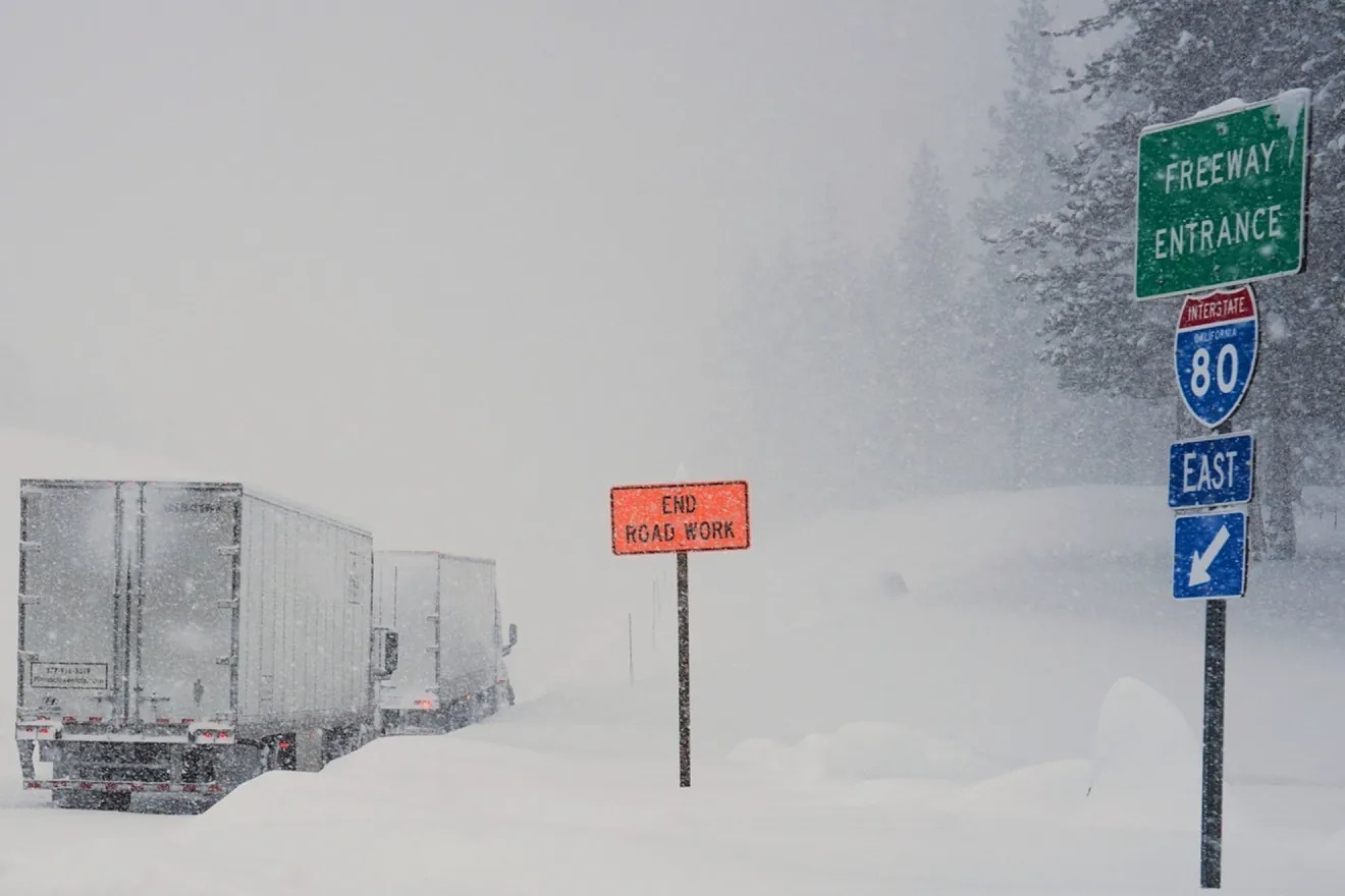 Trucks are lined up along Interstate 80 during a storm on Tuesday, Feb. 17, 2026 in Truckee Calif.