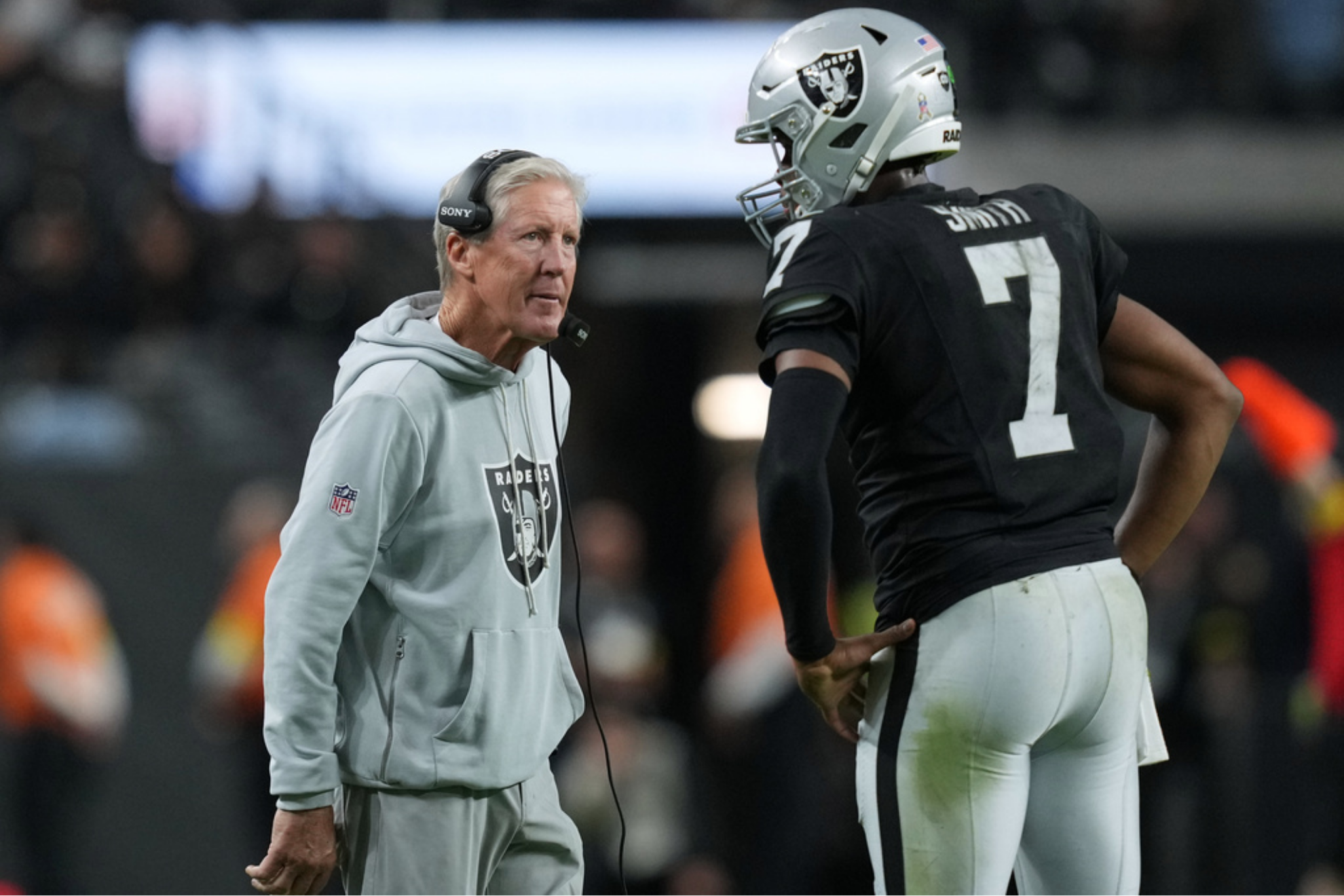 Former Las Vegas Raiders head coach Pete Carroll speaks with former Las Vegas Raiders quarterback Geno Smith