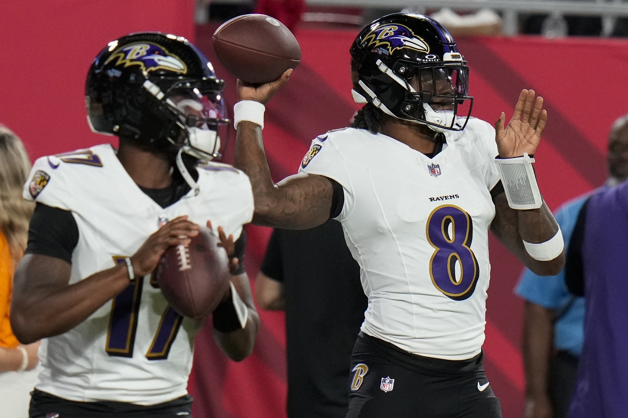 Baltimore Ravens quarterback Lamar Jackson (8) warms up next to quarterback Josh Johnson (17) before an NFL football game against the Tampa Bay Buccaneers