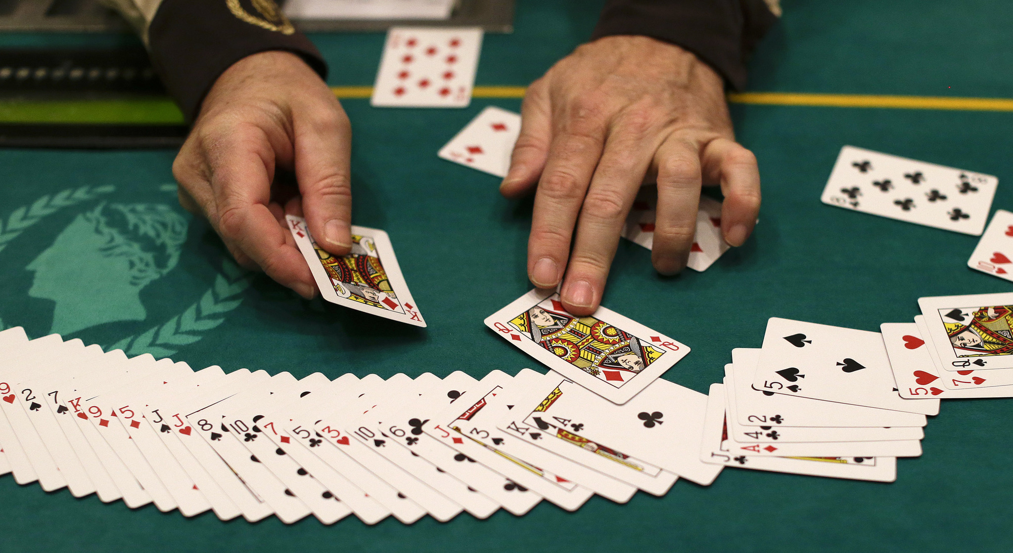 A dealer resets a deck of cards during a break in poker play at Caesars Palace, in Las Vegas
