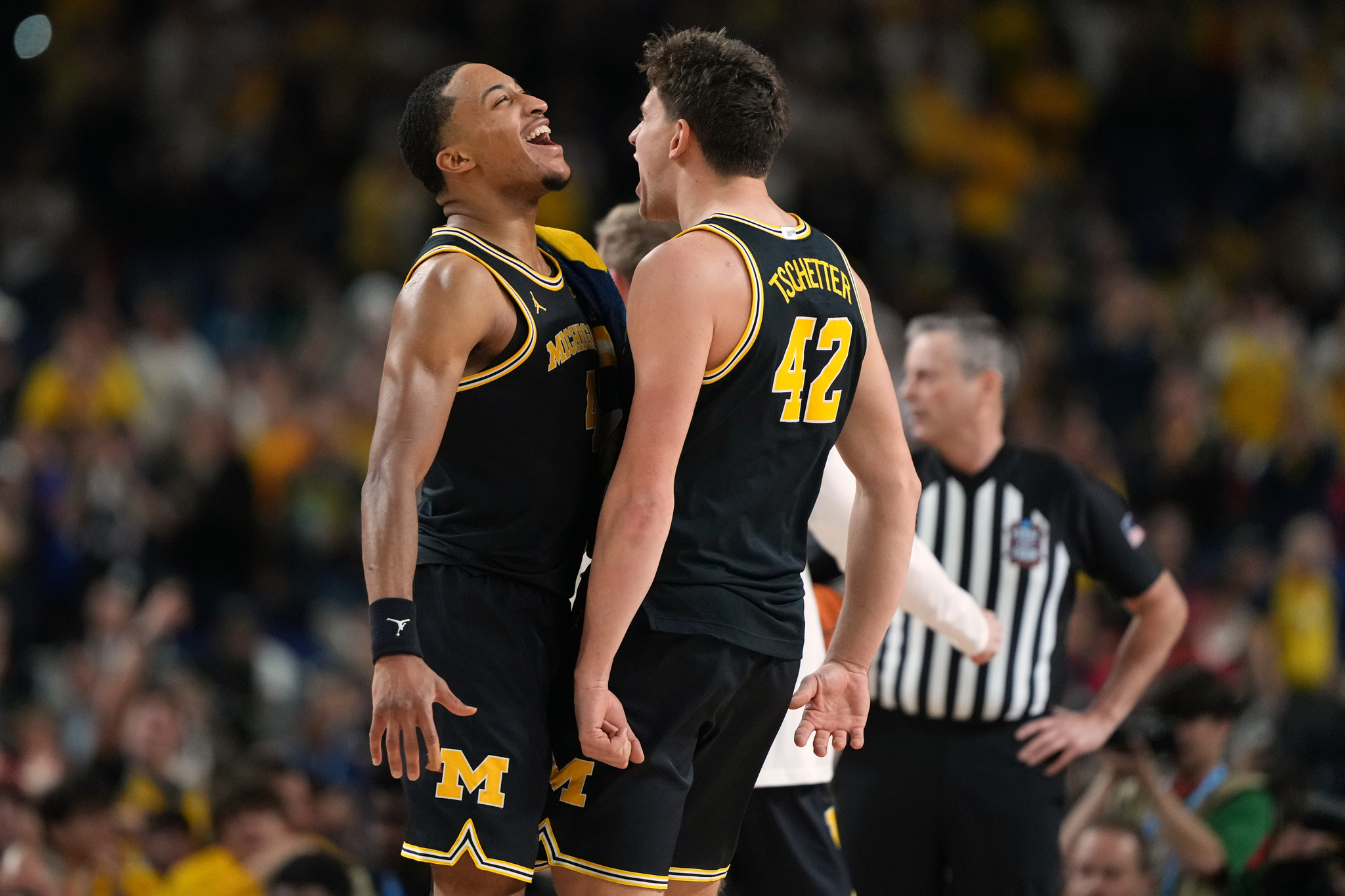 Michigans Nimari Burnett, left, and Will Tschetter (42) celebrate during the second half of an NCAA college basketball tournament semifinal game against Arizona at the Final Four