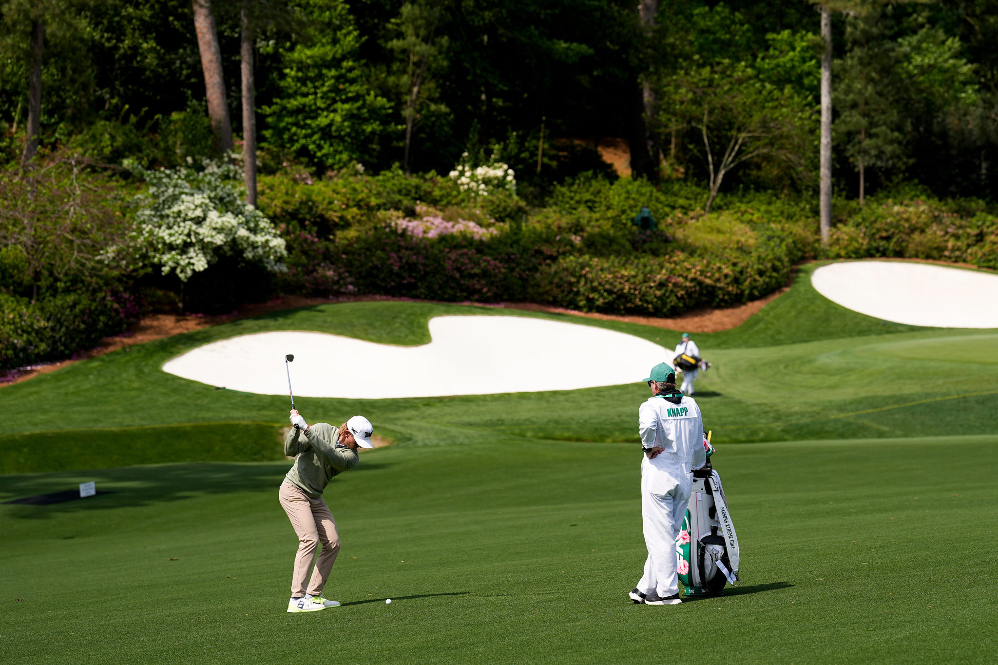 Jake Knapp hits from the fairway on the 13th hole during a practice round ahead of the Masters golf  tournament at the Augusta National Club