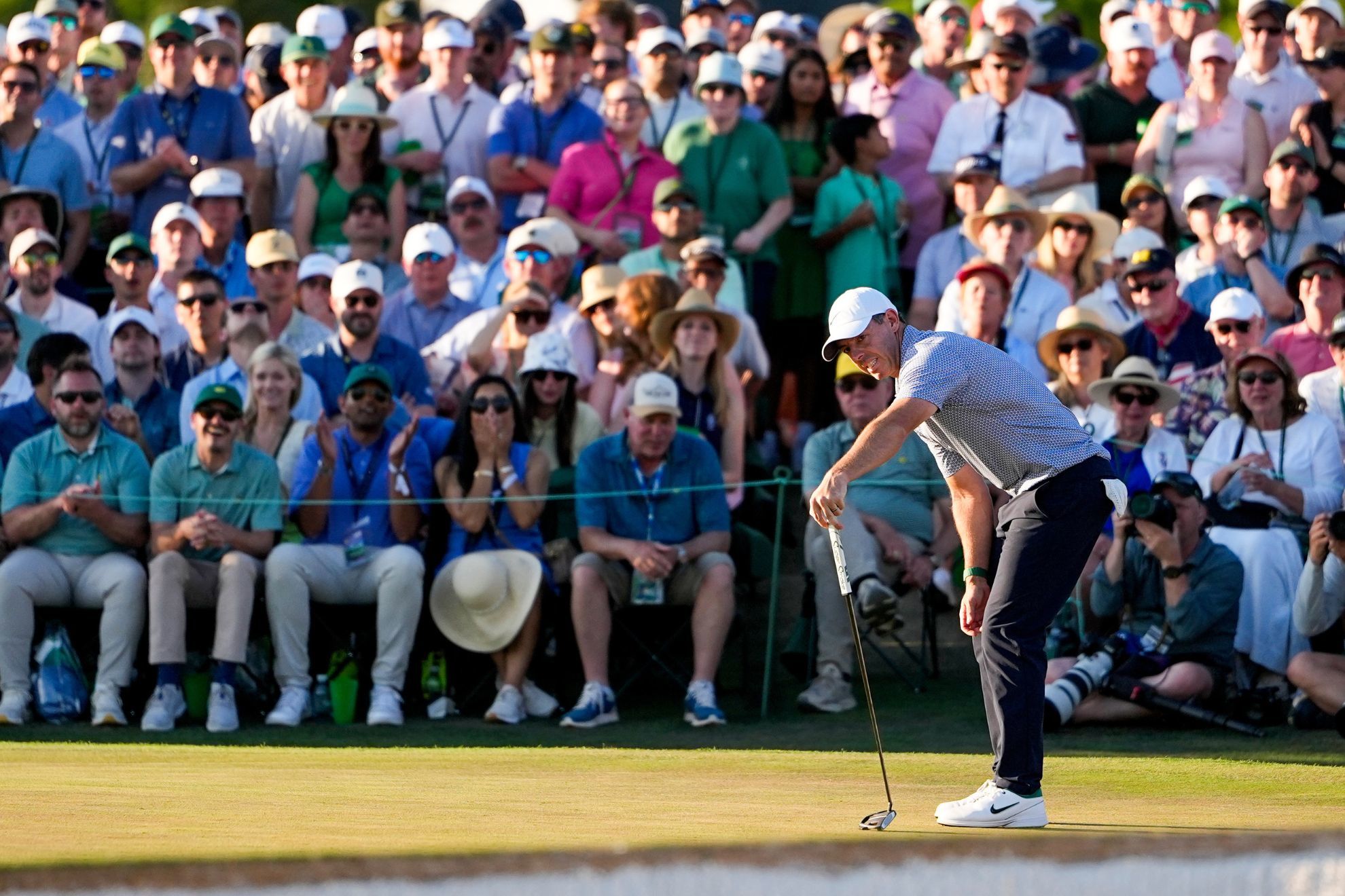 Rory McIlroy, of Northern Ireland, reacts after missing a putt on the 18th hole during the third round of the Masters golf tournament at the Augusta National Golf Club.