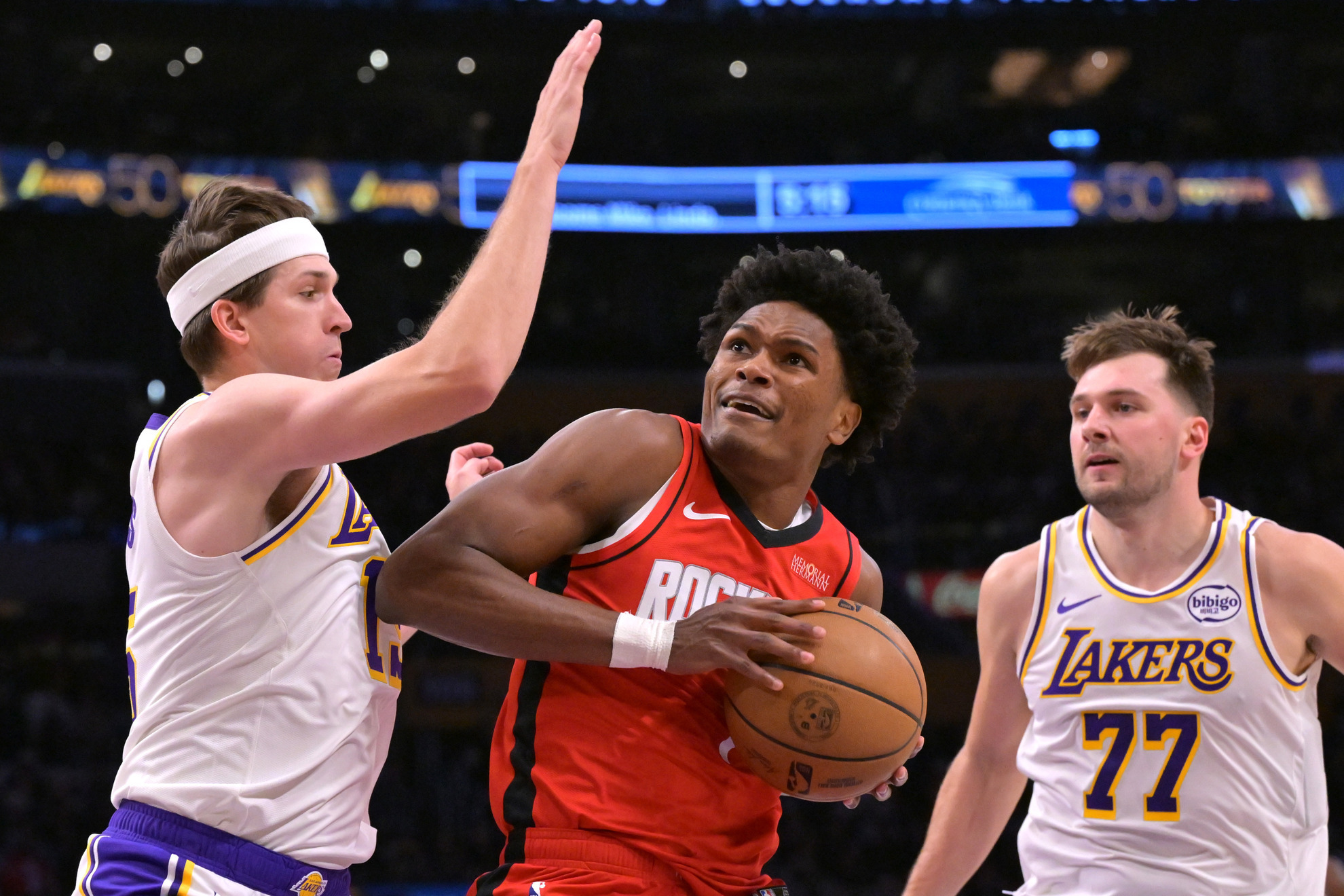 Los Angeles Lakers guard Austin Reaves and Lakers' guard Luka Doncic defend Houston Rockets guard Amen Thompson