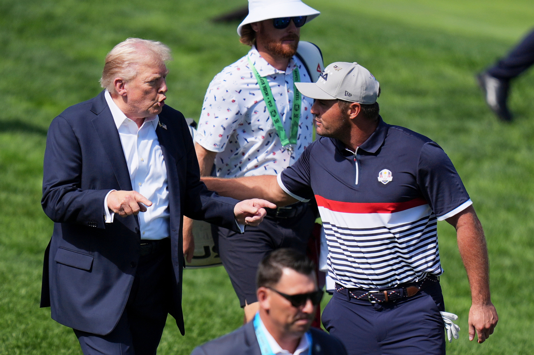 President Donald Trump greets United States Bryson DeChambeau on the first hole at Bethpage Black golf course during the Ryder Cup golf tournament