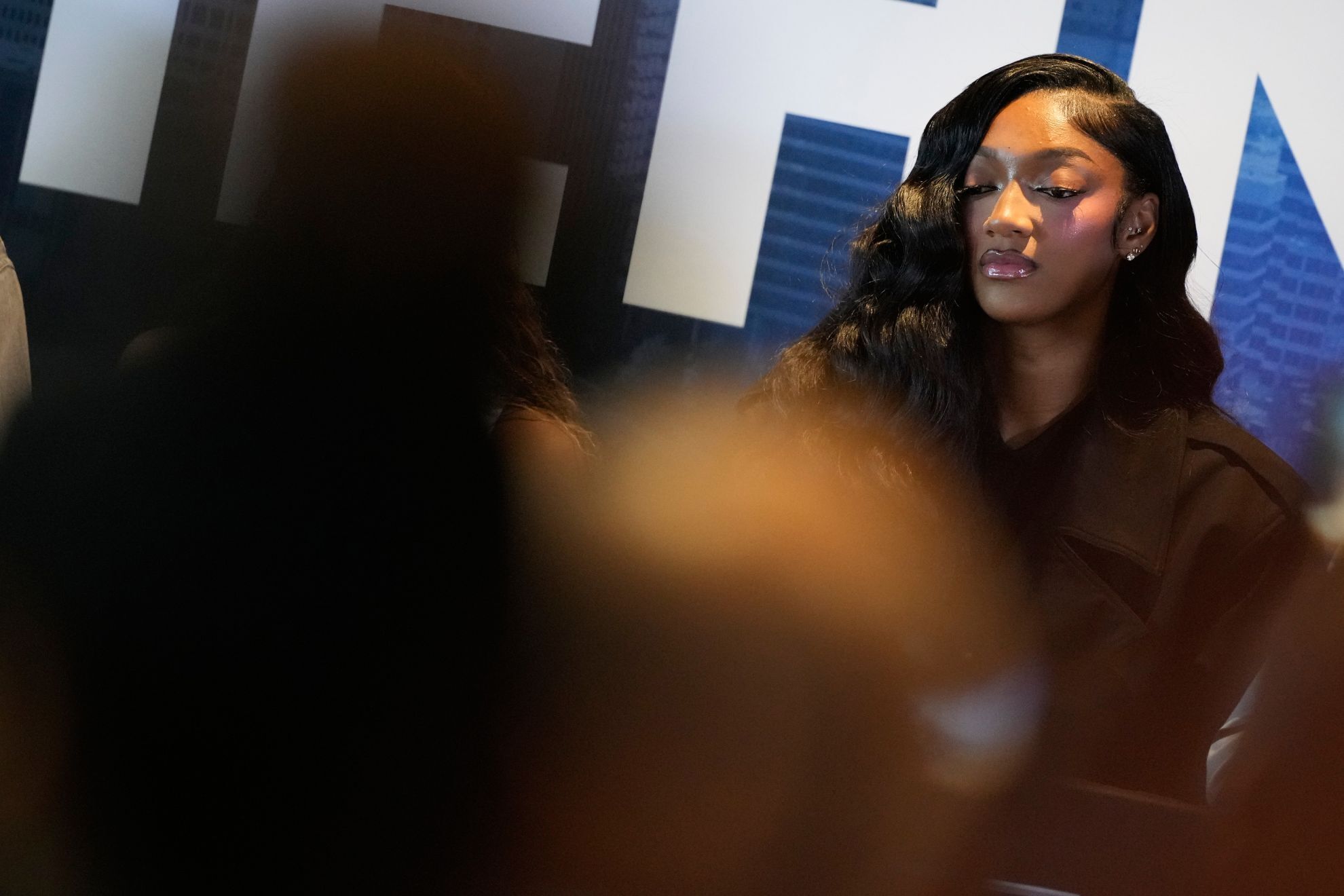 Angel Reese listens with laughs and knowing glances as her new teammates share their comments