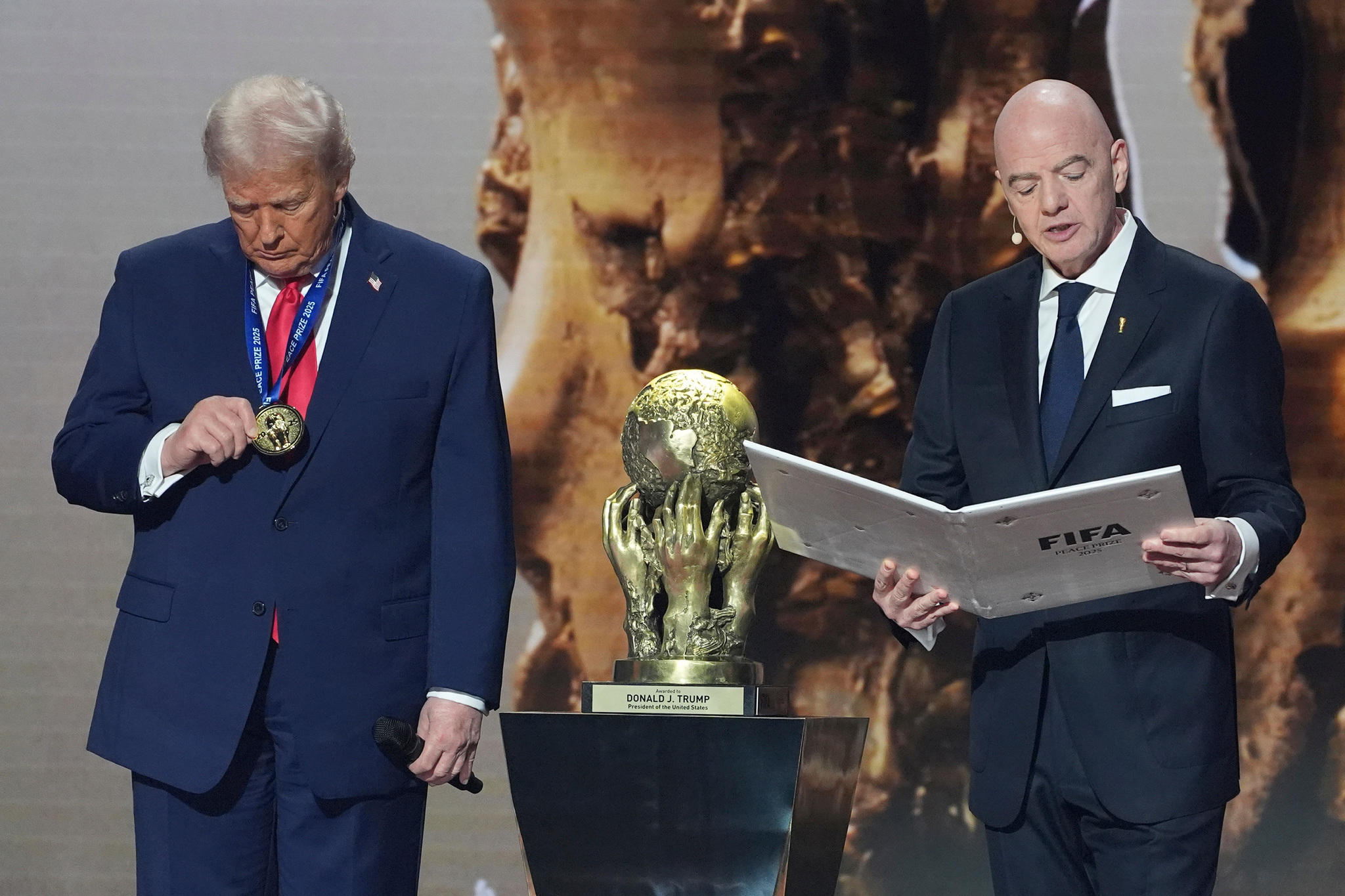 President Donald Trump is presented with the inaugural FIFA Peace Prize by FIFA President Gianni Infantino during the 2026 FIFA World Cup draw at the Kennedy Center