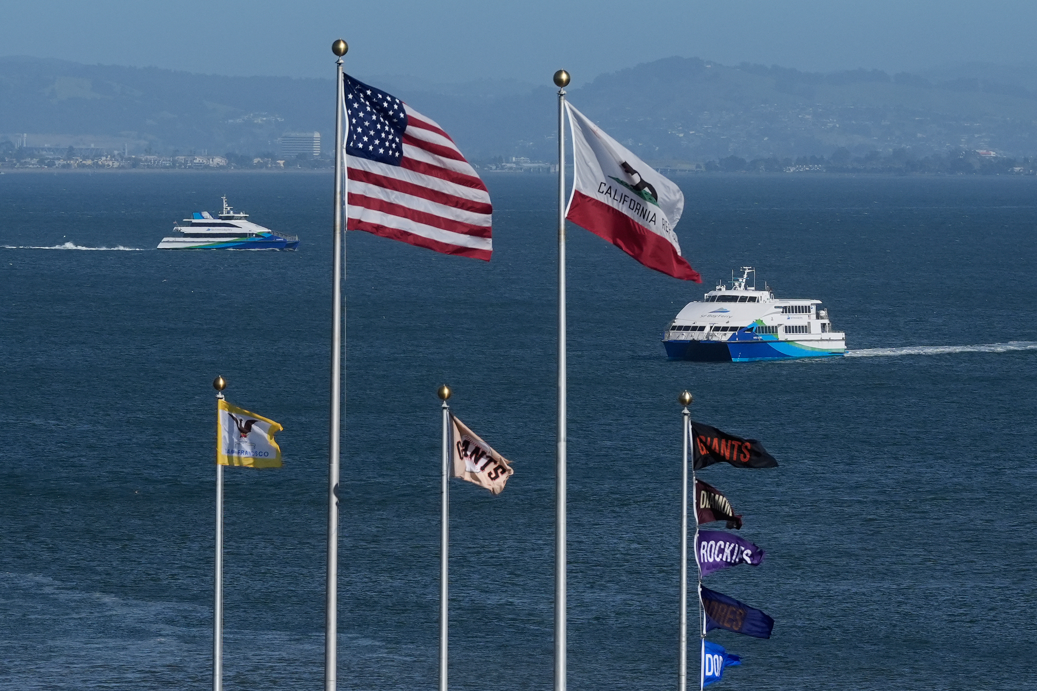 US and California flags fle above an MLB game.