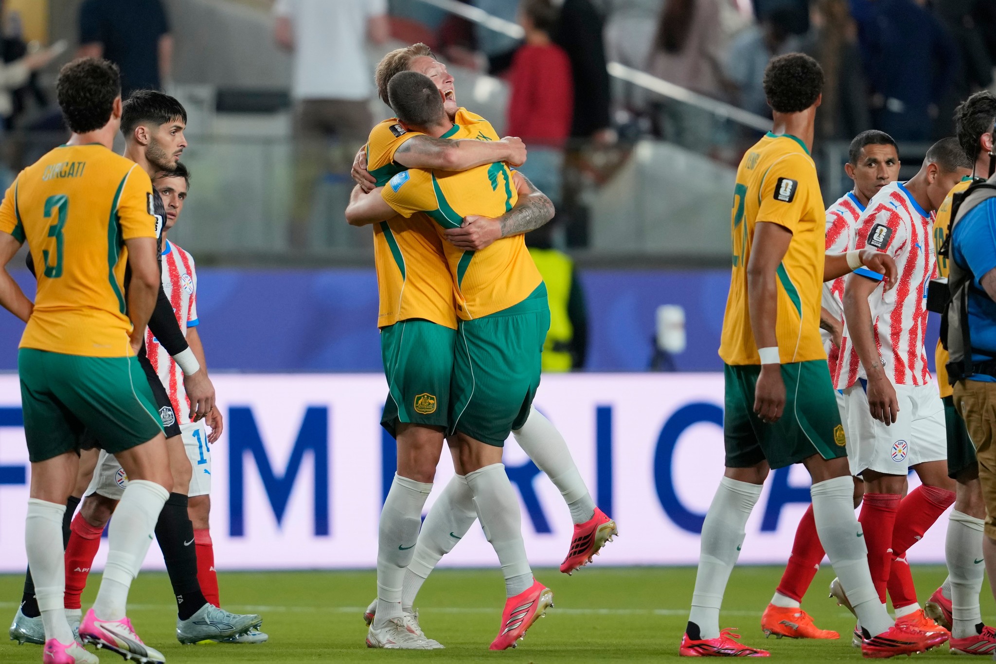 Australia's Milos Degenek (2) celebrates with his teammate Harry Souttar (19) during the World Cup Group D soccer match between lt;HIT gt;Paraguay lt;/HIT gt; and Australia in Santa Clara, Calif., near San Francisco, Thursday, June 25, 2026. (AP Photo/Eugene Hoshiko)