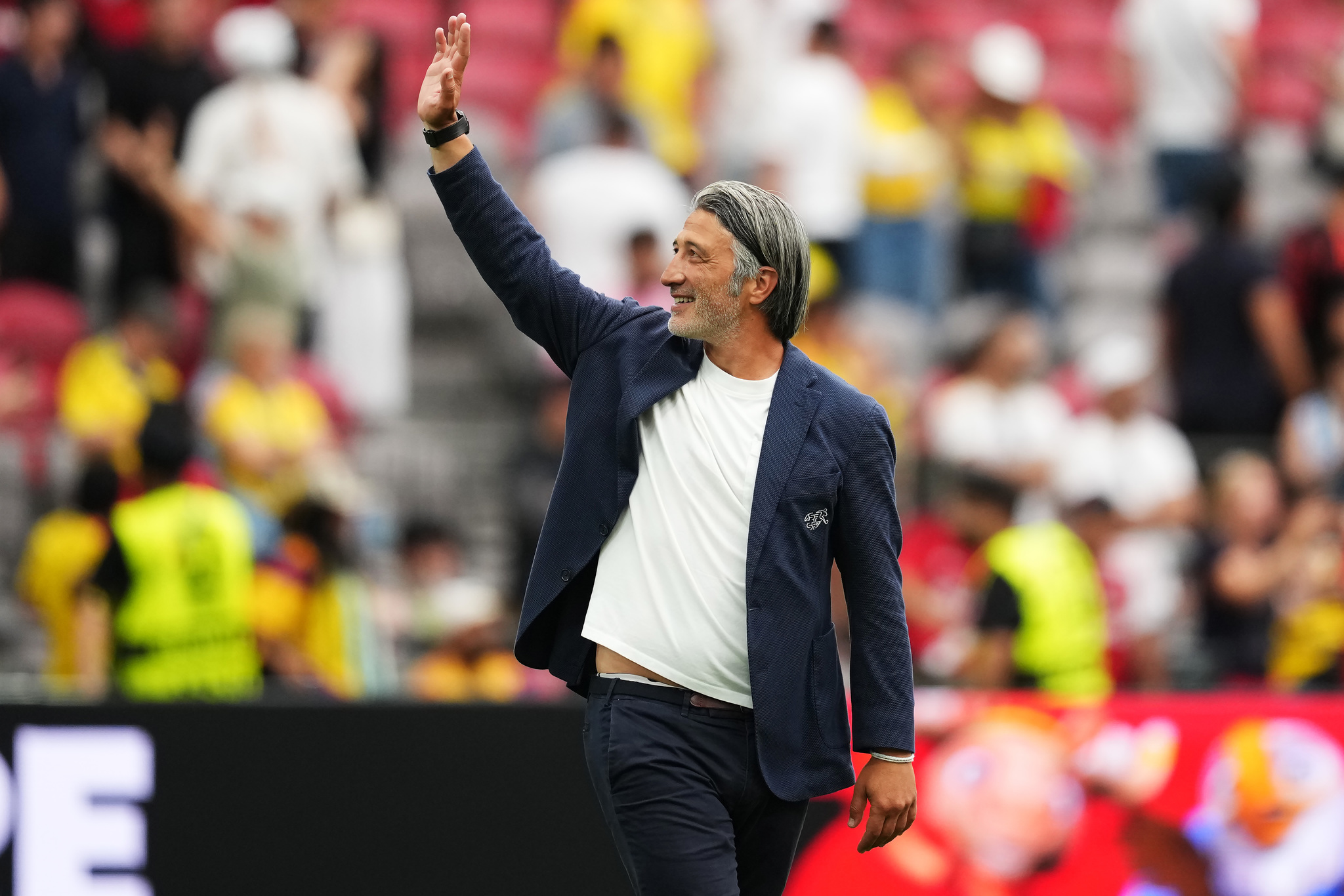 Switzerland manager lt;HIT gt;Murat lt;/HIT gt; lt;HIT gt;Yakin lt;/HIT gt; waves to fans after defeating Colombia in the penalty kick shootout the World Cup round of 16 soccer match between Switzerland and Colombia in Vancouver, British Columbia, Tuesday, July 7, 2026. (Ethan Cairns/The Canadian Press via AP)